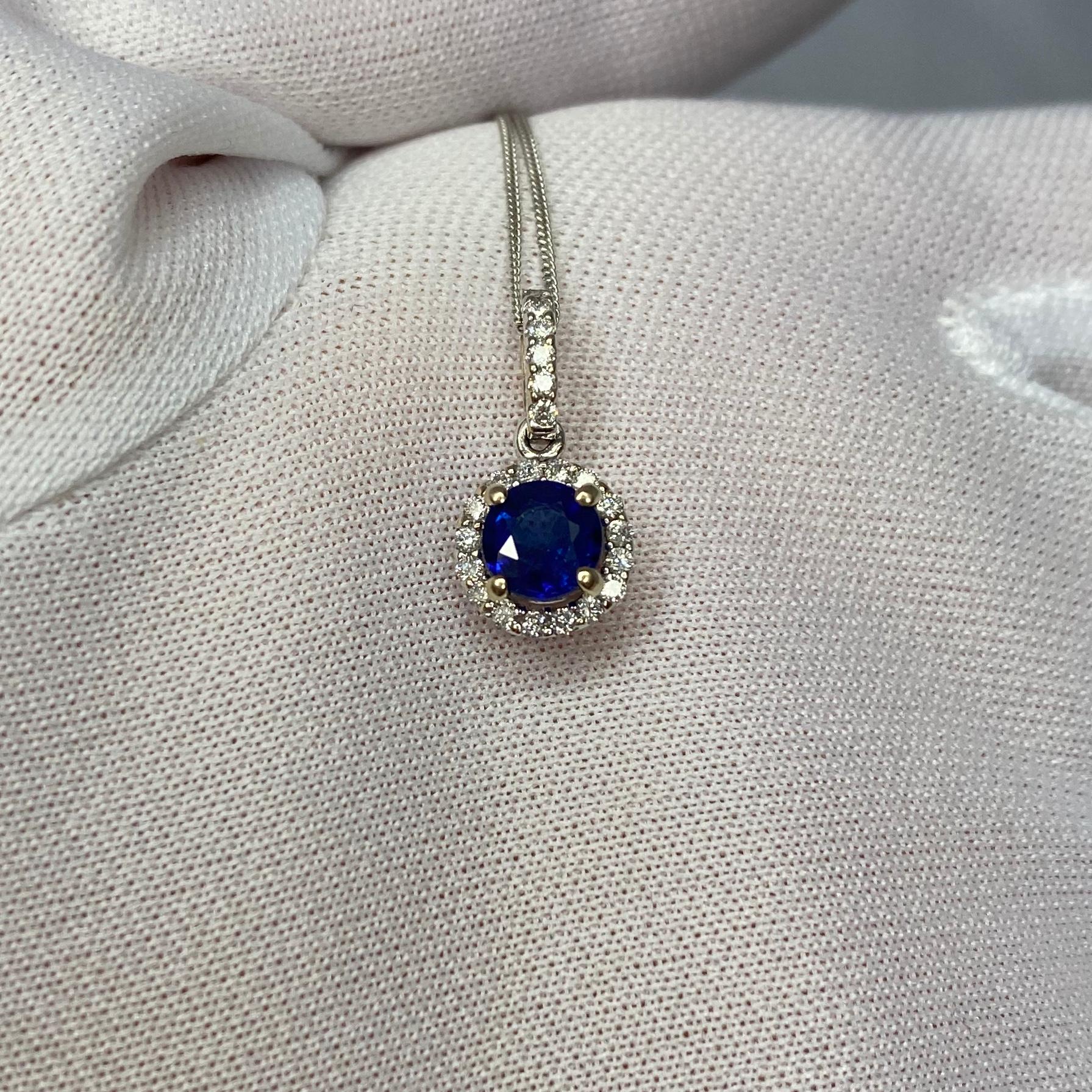 Stunning natural deep blue sapphire set in a fine 18k white gold diamond cluster pendant.

0.69 carat centre sapphire with a deep blue colour and good clarity.
Some small inclusions when looking closely but not a dirty stone.

The pendant is hanging