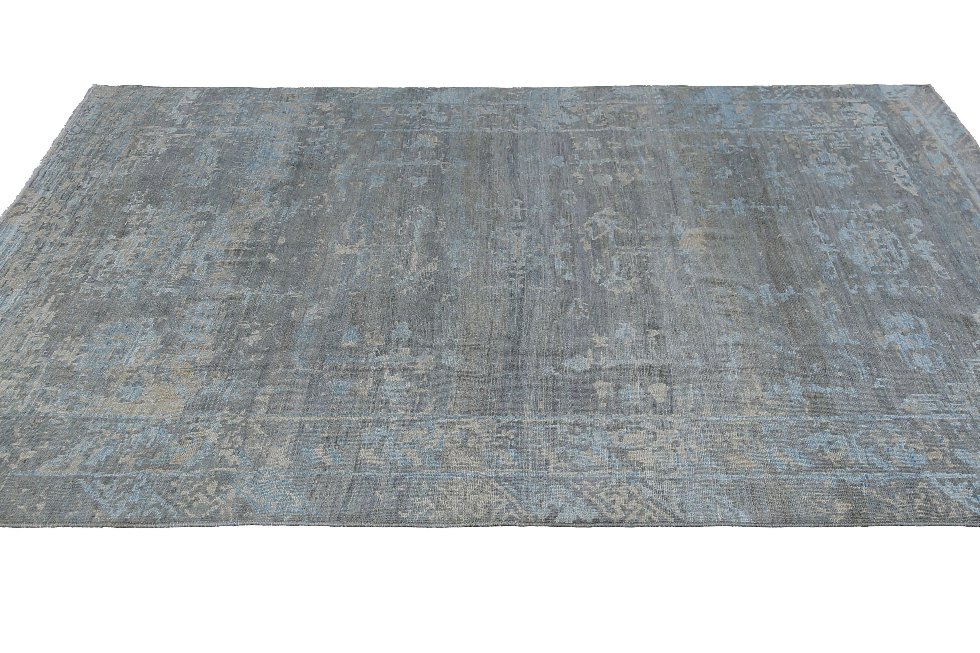 Our Turkish rug in the size of 9'2'' x 11'10'' is a stunning addition to any space, featuring deep blue colors that create a sense of calm and tranquility. Handcrafted using high-quality wool, this rug is both durable and soft to the touch. The