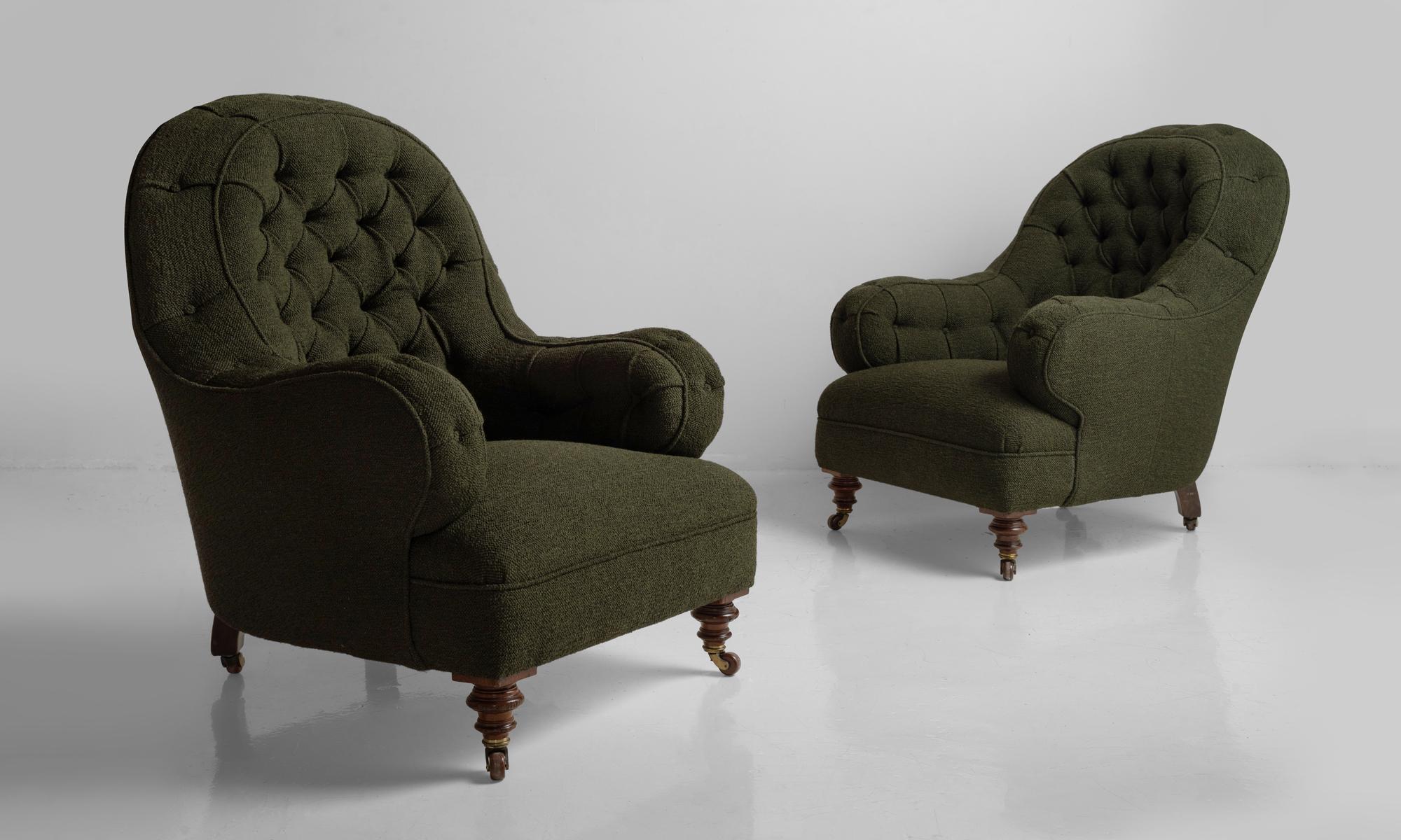 Deep buttoned armchairs, England, circa 1860.

Newly reupholstered with turned walnut front feet.