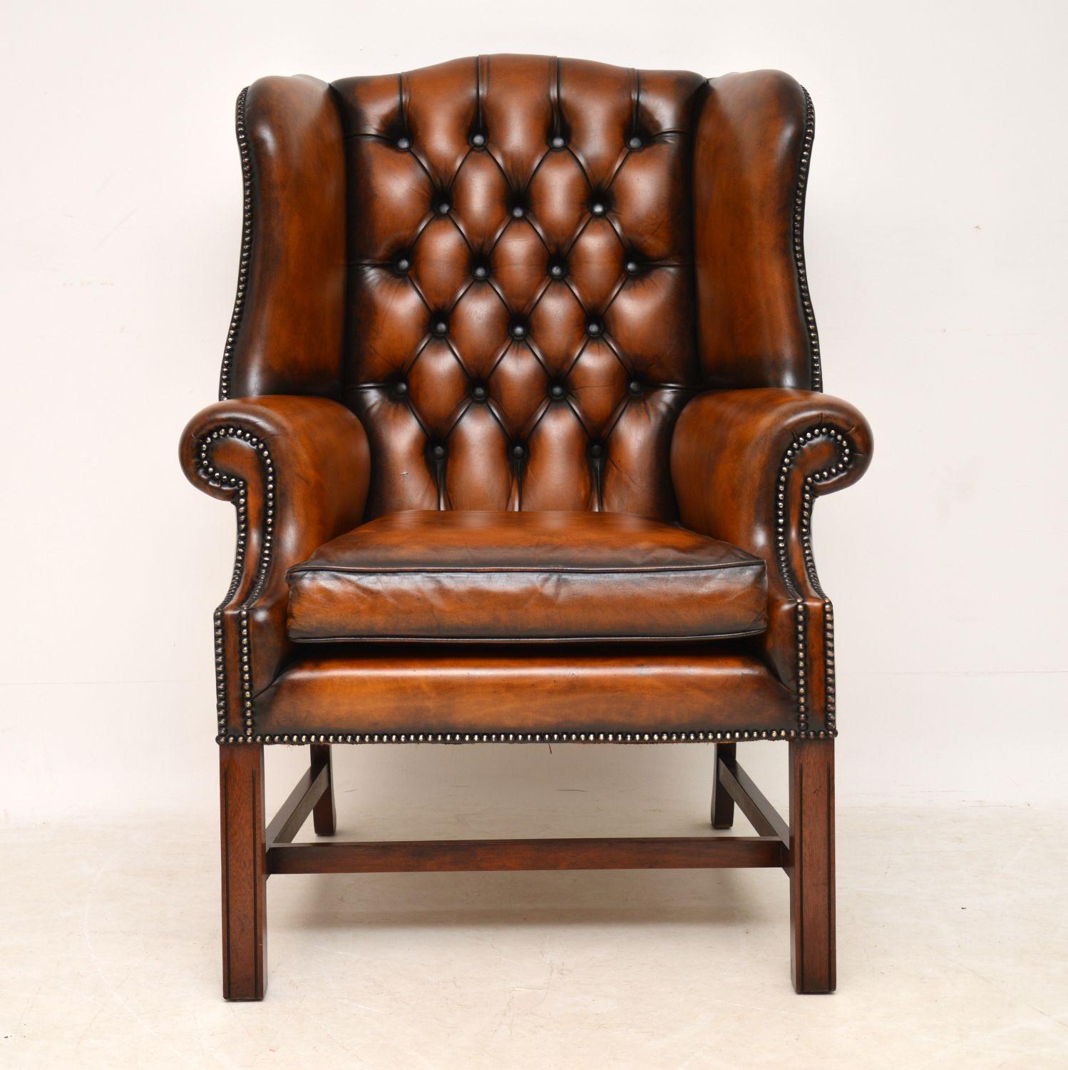 Antique George III style brown leather wing armchair with a deep buttoned back and dating from circa 1950s period. This armchair is in very good condition and has loads of character, having just been revived and polished by our leather expert. It’s
