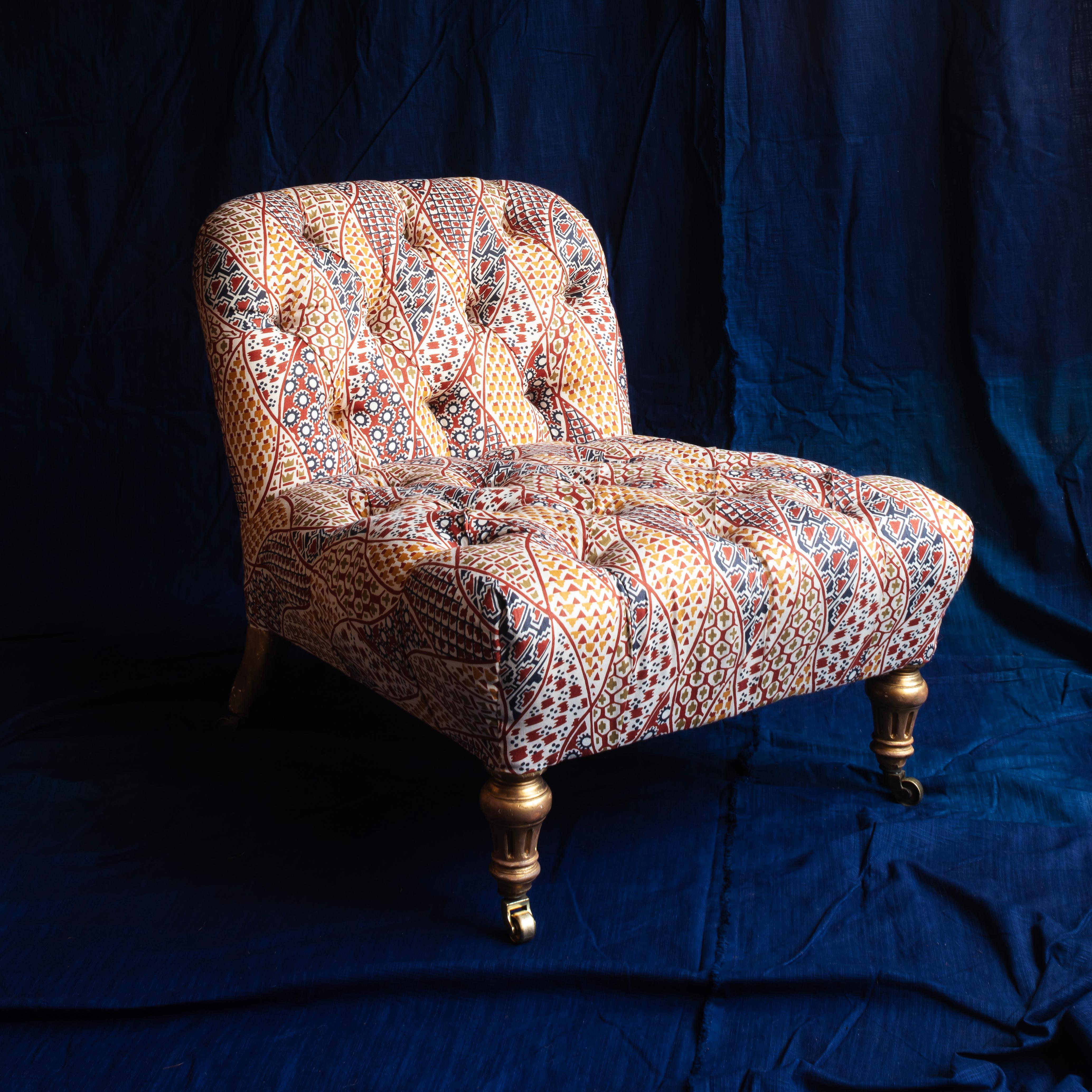 Deep buttoned slipper chair with carved gilt legs attributable to Gillow’s. Covered here in ‘Suze’ from our Soane fabric collaboration.
Dimensions: Height: 66 x Width: 66 x Depth: 72 cm