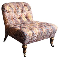 Deep buttoned slipper chair with carved gilt legs attributable to Gillow’s.