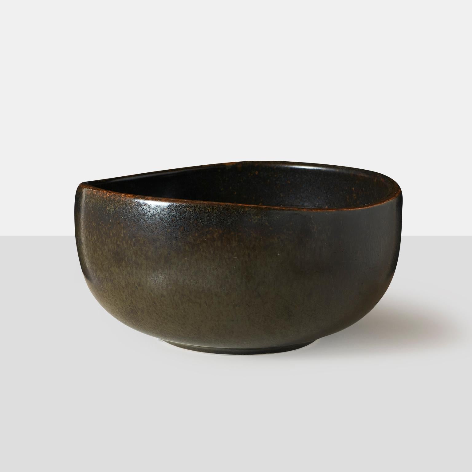 Eva Staehr-Nielsen for SAXBO dark brown glaze, rounded bowl with organic shape. The underside is incised with the artist's initials E.ST.N., stamped Saxbo, Denmark, the ying-yang symbol, 4 dots, the numbers 446 and 8.