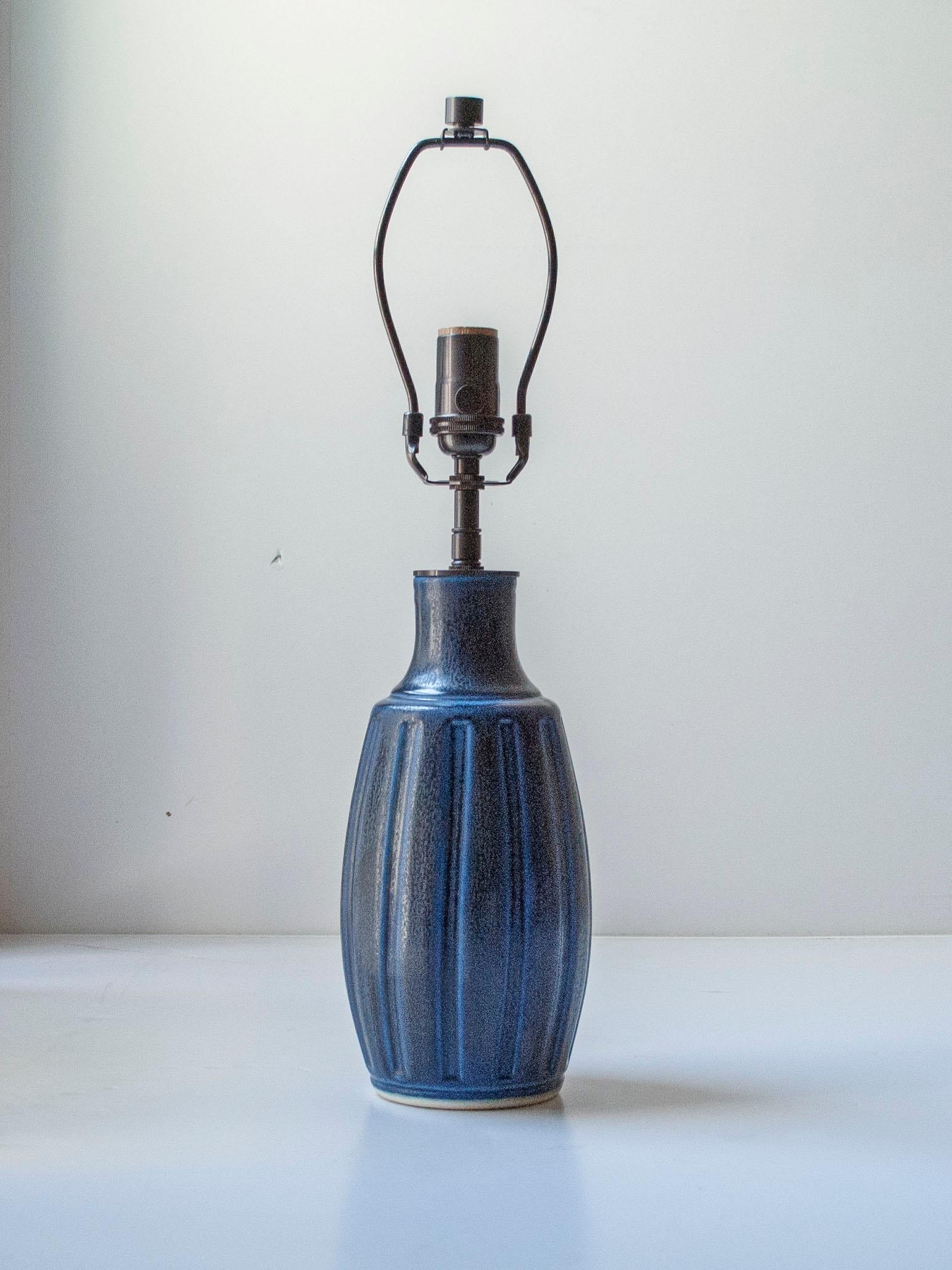 Lampada da tavolo in ceramica smaltata color cobalto di Wilhelm Kåge per Gustavsberg, Svezia, 1950 ca.

Lampada da tavolo alta in porcellana blu con motivo scolpito di Wilhelm Kåge per Gustavsberg.

Questa lampada è stata ricavata da un vaso, senza
