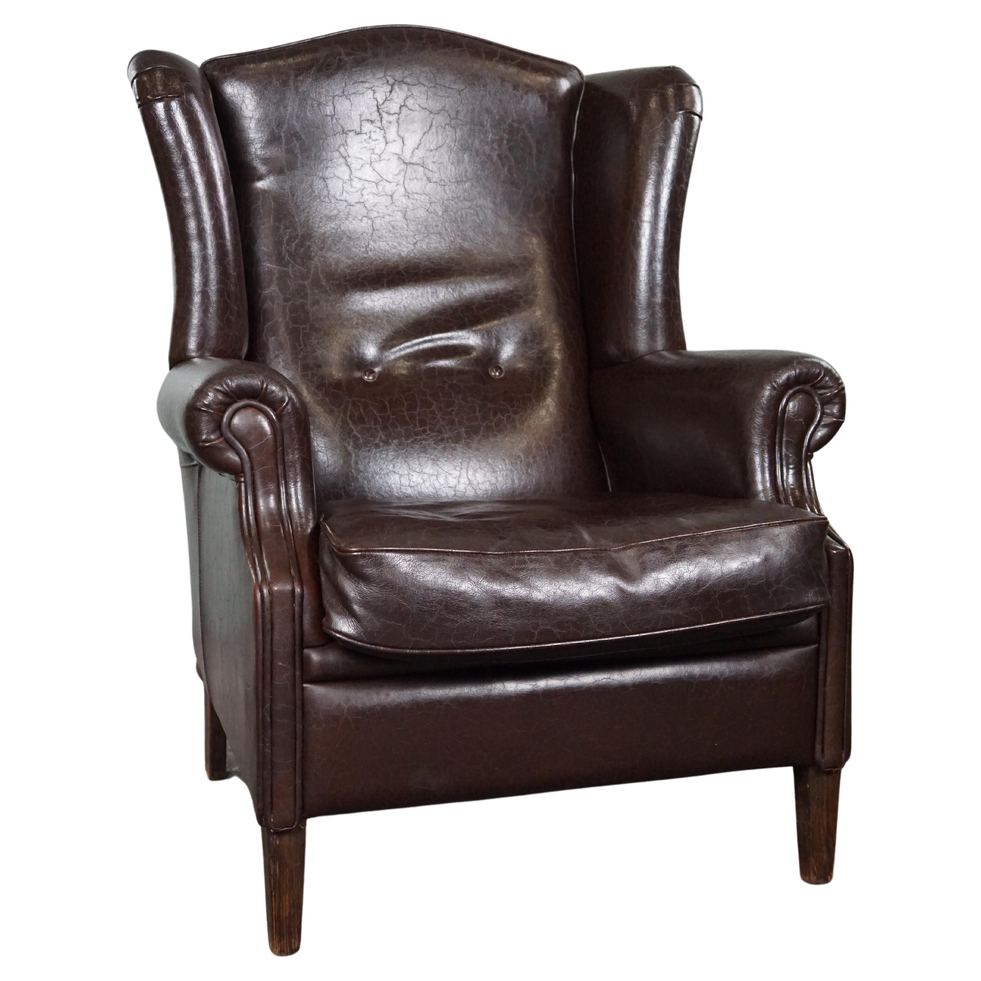 Deep dark brown leather wingback armchair in English style For Sale
