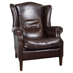 Deep dark brown leather wingback armchair in English style