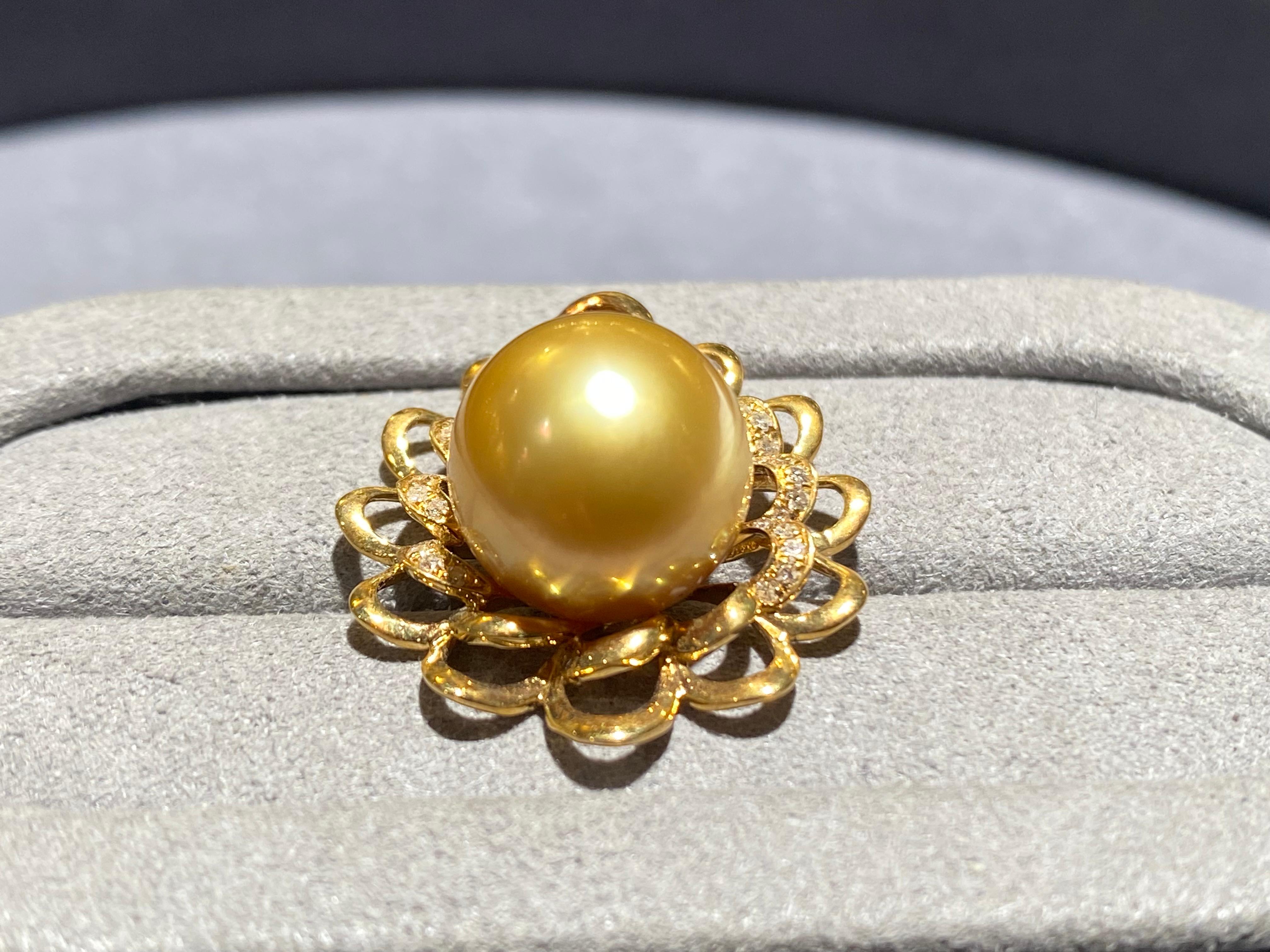 A 12.4 mm deep golden colour south sea pearl and diamond pendant in 18k yellow gold. It is a floral design pendant with the south sea pearl sitting in the middle with diamond pave surrounded it. The south sea pearl is round in shape. The pearl is