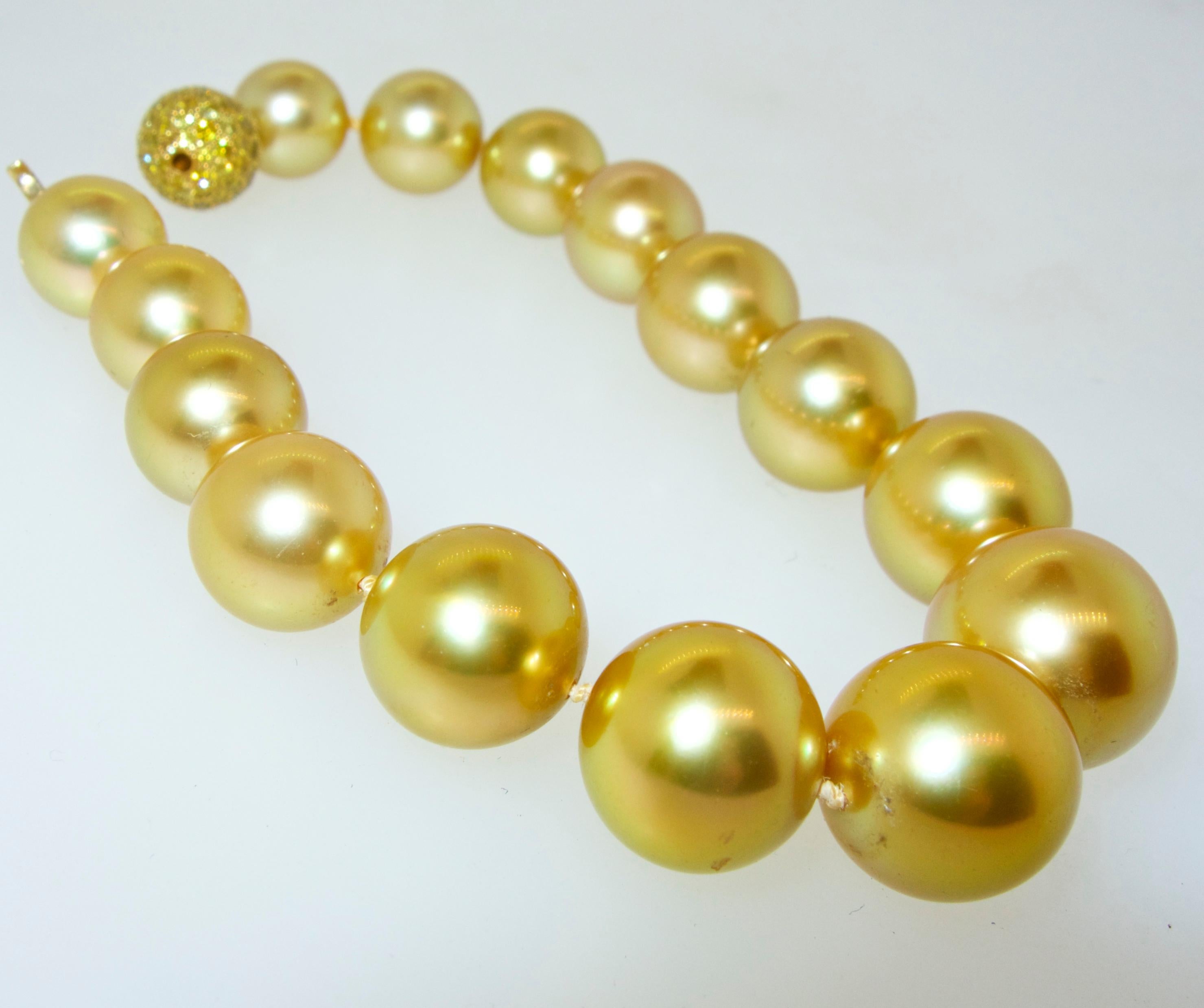 15  true gem  deep golden South Sea pearls slightly graduating in size, from 10.5 up to 14.35 mm.  The color is a vibrant deep gold color, the skins are clean with fine deep luster and these spherical pearls are well matched.   We see many strands