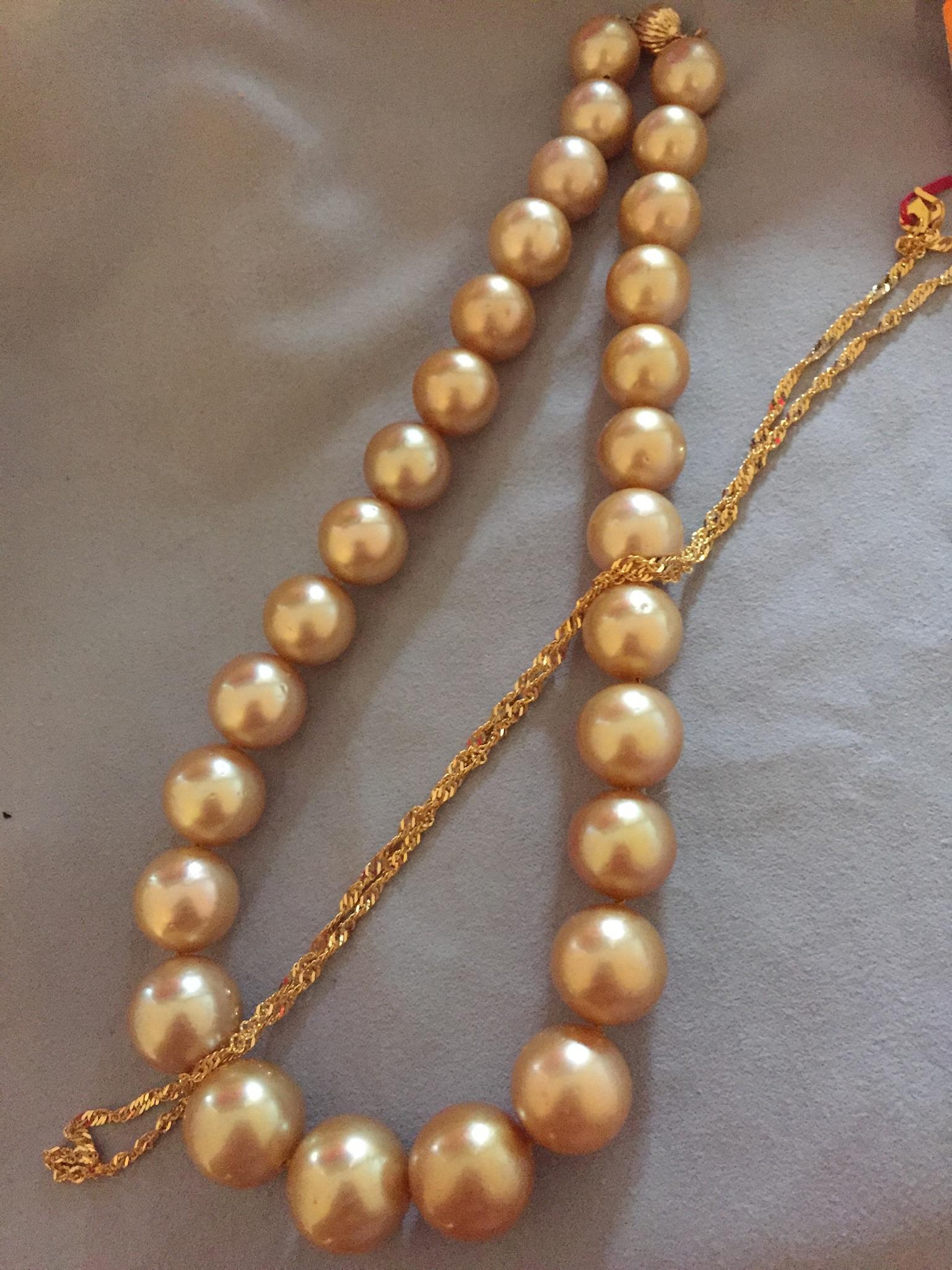 This is an impressive Deep Golden South Sea Pearl Necklace with 18K Ruby and Diamond Clasp. The pearls are 12mm-16mm in size and it comes with a 18K Ruby and Diamond Clasp. The ruby is 
