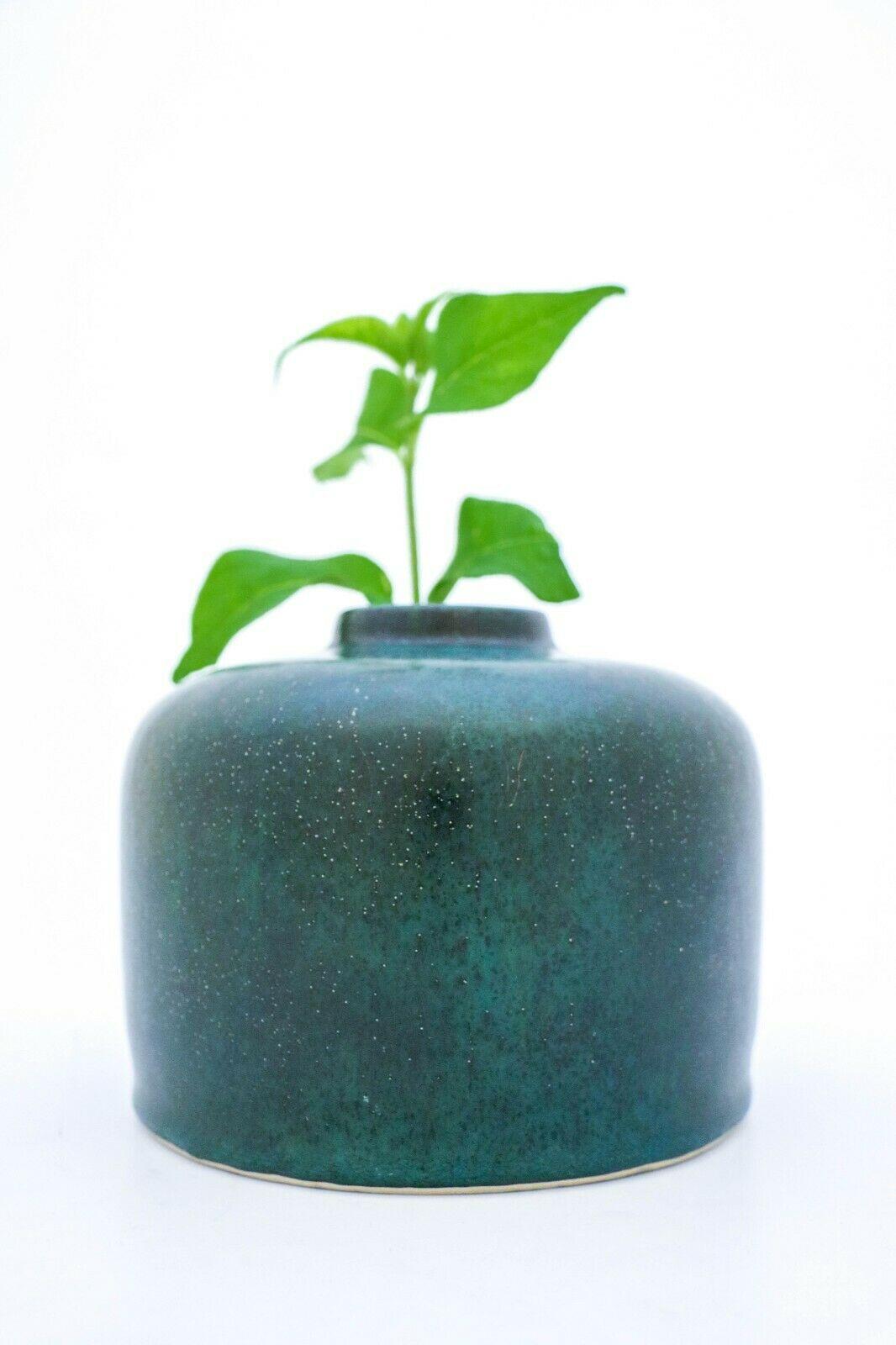 A deep green vase designed by Carl-Harry Stålhane at Rörstrand, it´s 12,5 cm high and 15.5 cm in diameter. It´s in mint condition. It´s dated 1963 and it is a unique vase. It has a lovely glaze. 
 