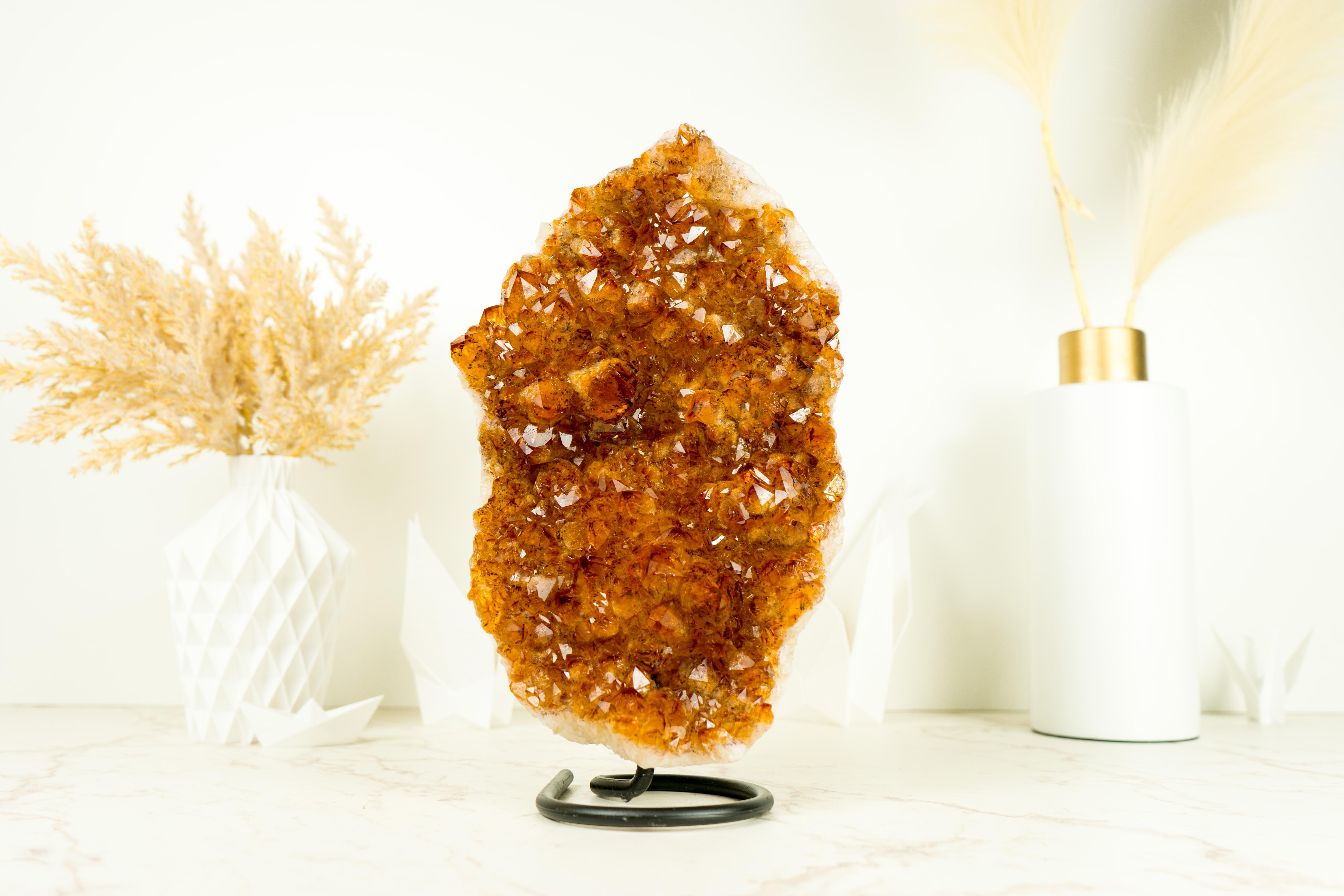 This deep Orange, almost Red, Citrine Cluster was handpicked for its rare color tone and wonderful aesthetics. A unique citrine specimen that showcases a natural masterpiece, making it an extraordinary addition to any collection or decor, elevating