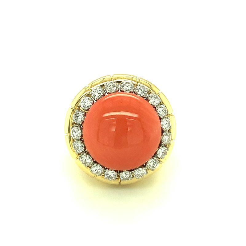 Centering one deep pink cabochon coral with a diamond border featuring 19 round brilliant cut diamonds weighing 1.45 ct. with G color and VS-1 clarity. Vibrant, colorful, fashionable.

Additional information:
Metal: 18K Yellow Gold
Gemstone: Coral -