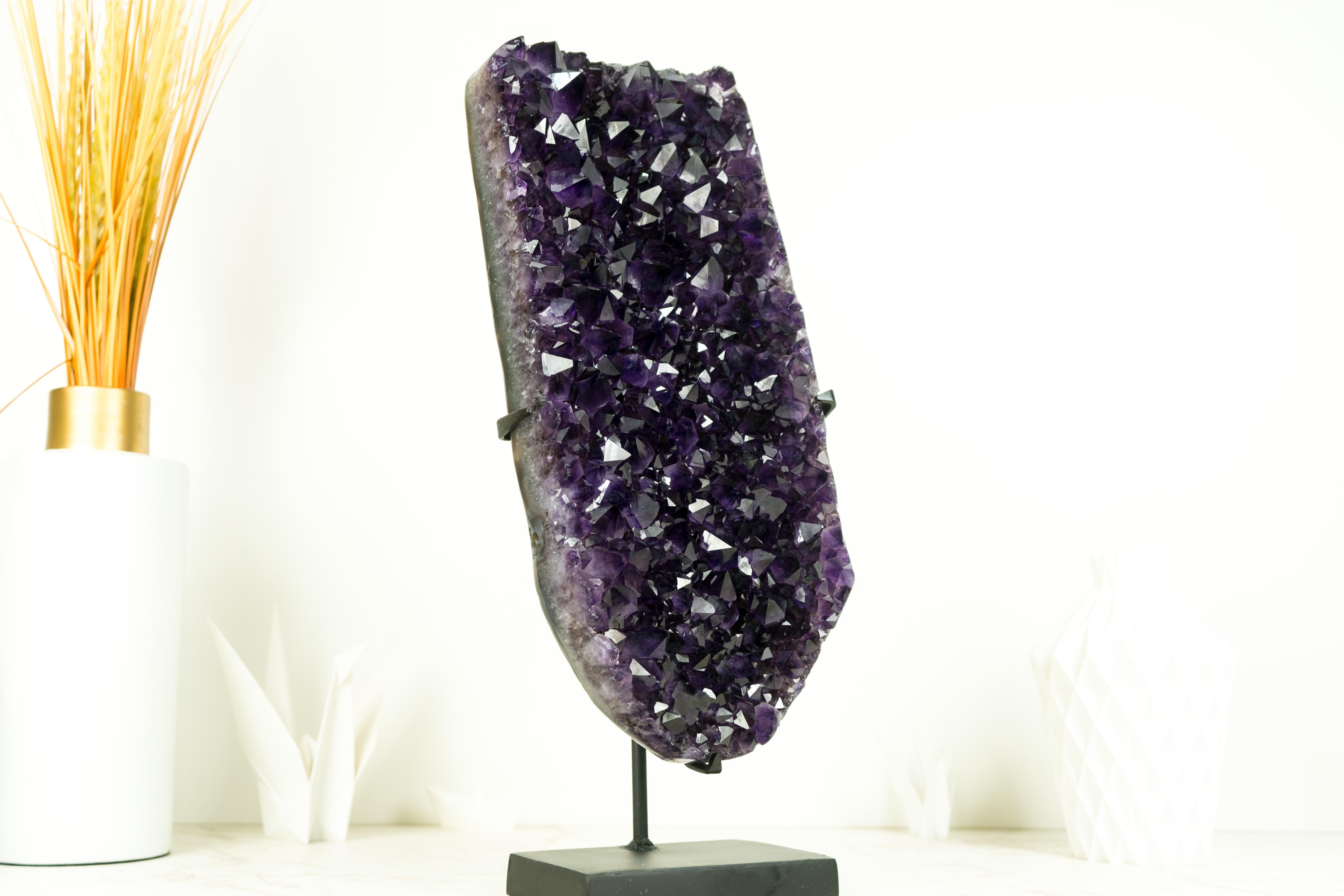 An Amethyst Cluster of exceptional beauty, this piece showcases the deepest shade of purple, AKA Grape Jelly Amethyst, on a beautifully formed Amethyst Cluster. It's a truly spectacular specimen that will elevate the space of your home, office, or