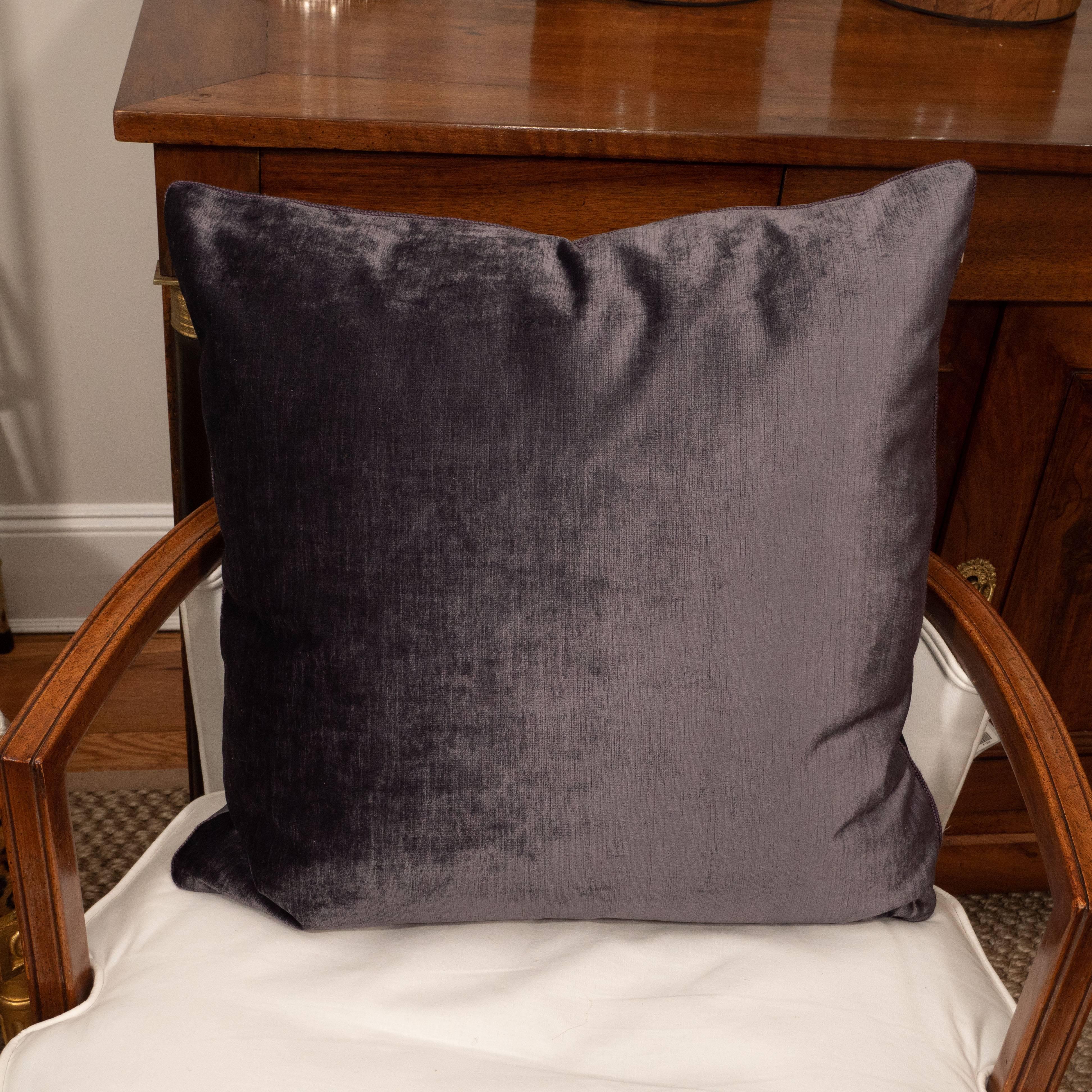Deep purple velvet cushions with cording.