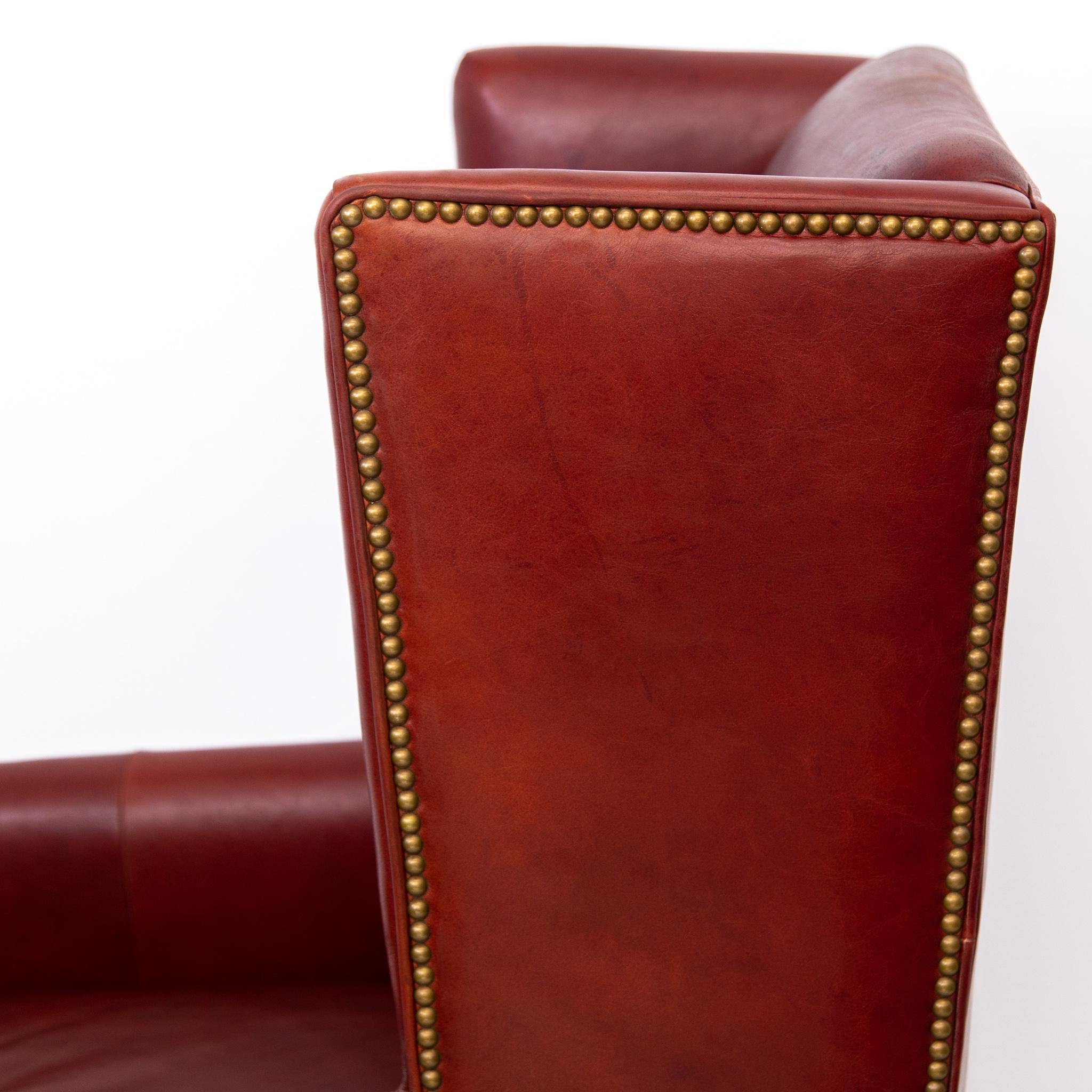 American Craftsman Deep Red Leather Wingback Fireside Chair with Brass Nailhead Trim by Massoud