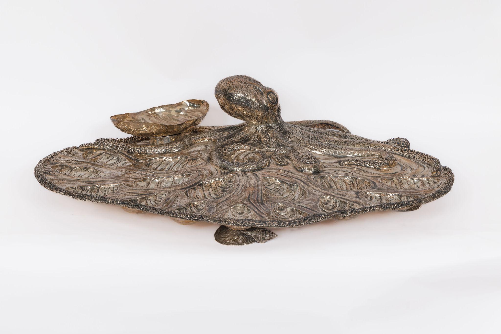 Deep Sea Majesty: Buccellati Sterling Silver Marine Theme Oyster Tray with Octopus

This exceptional work from Buccellati’s marine-inspired oeuvre brings the ocean’s mythic allure to your tabletop. At its heart lies a lifelike octopus, its finely