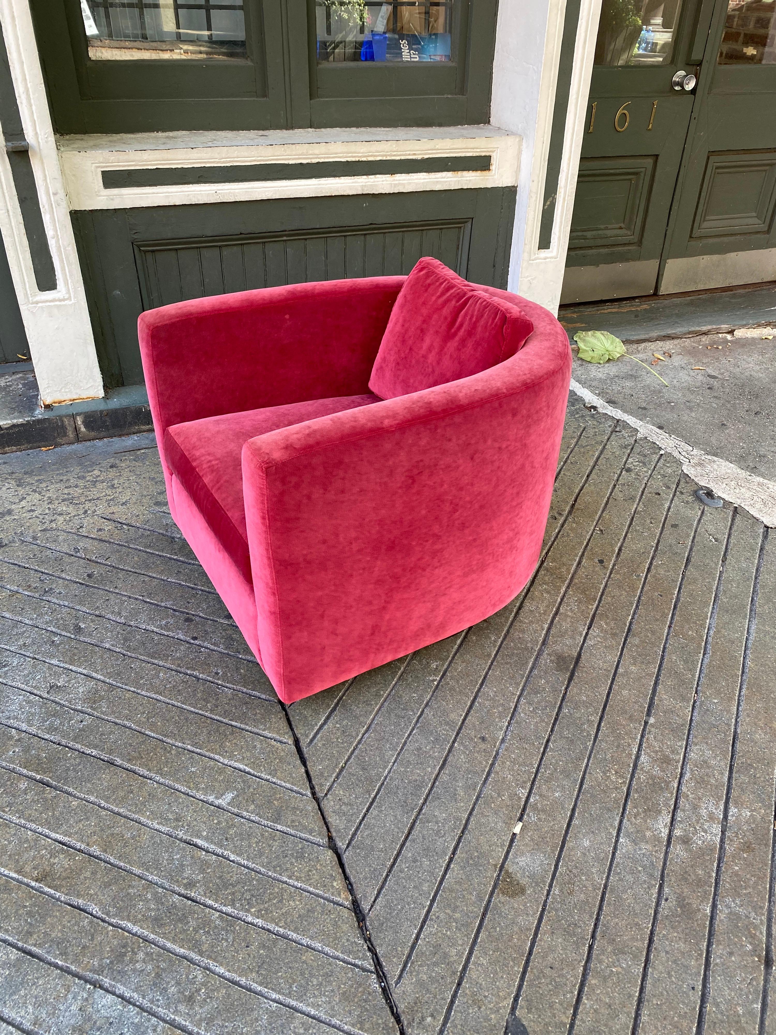 Extra deep swivel tub chair. Very sleek profile with an exaggerated deep seat. Seats very well with the small back pillow for your back. Covered in a strawberry velvet. Chair probably dates from the late 1970s, fabric I believe is original and looks