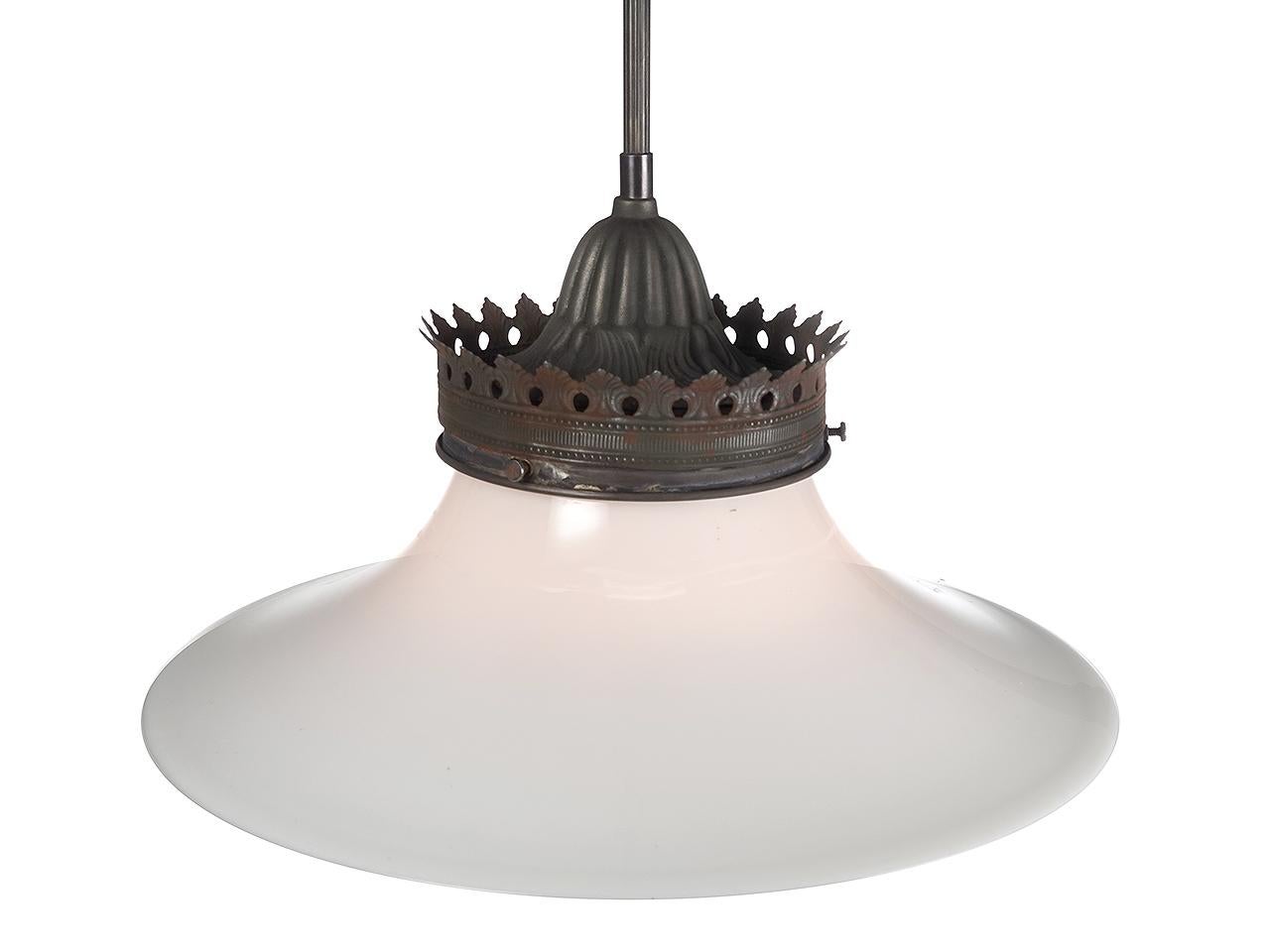 We only have one early pendent in this style. The large milk glass shade has a long sweeping profile that is very pleasing. The crown has a decretive stamping and a domed fluted casting.