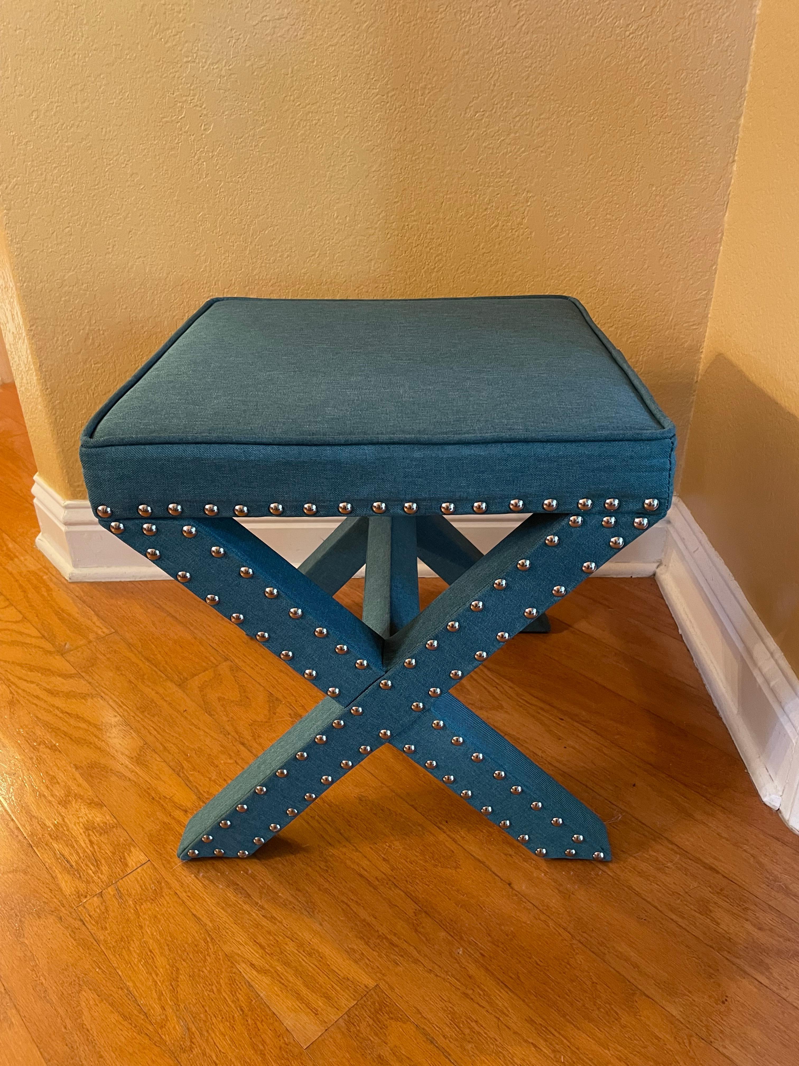 This versatile and iconic X bench is like new. It's more of a deep blue-green turquoise color with silver nail heads that run along the outside of the entire bench. The X Bench is proportioned so well. I think this is part of its enduring appeal.