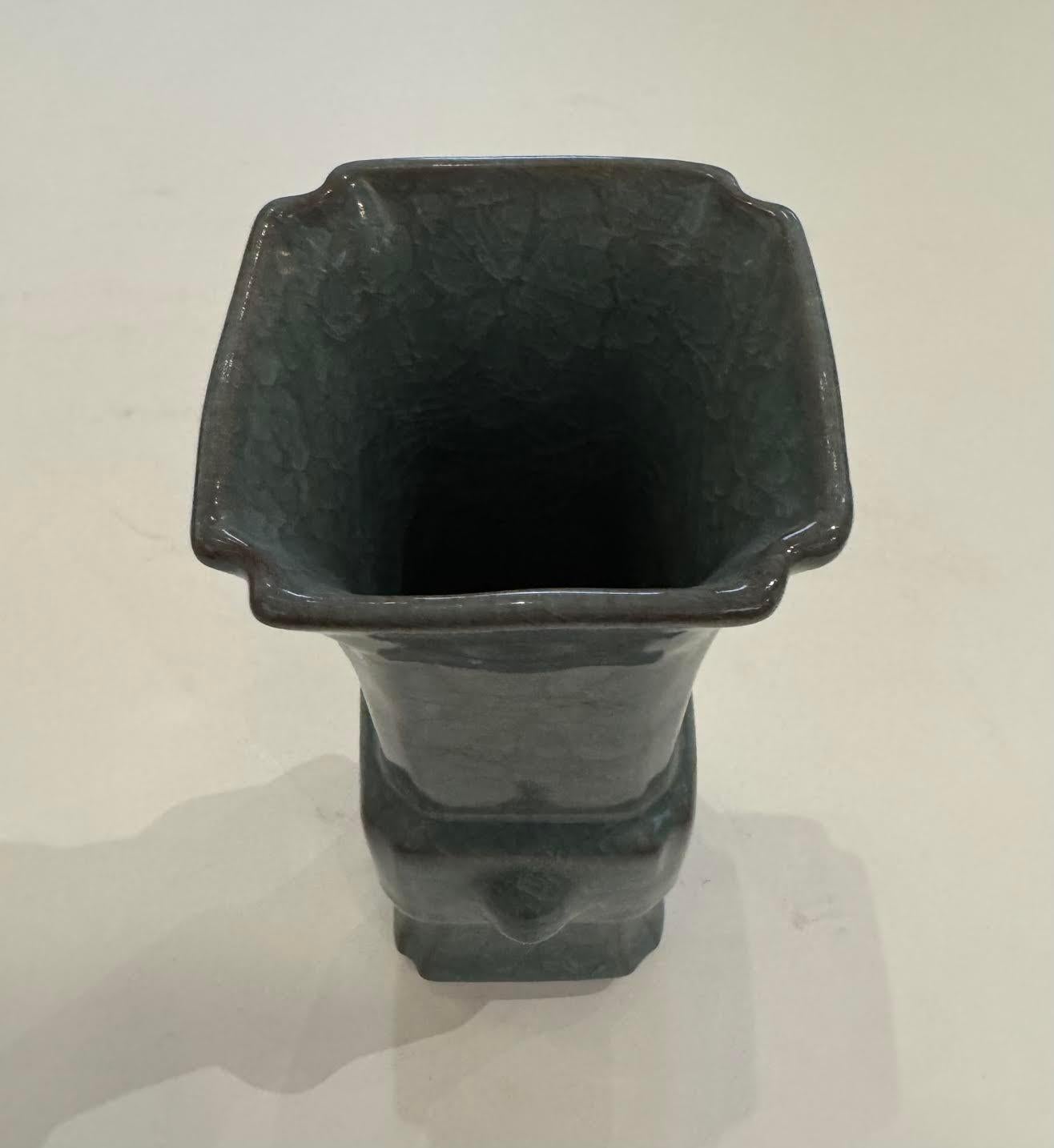 Contemporary Chinese deep turquoise vase. 
Non contrasting crackle glaze.
One of many from a large collection.
Square shape with decorative notch details.