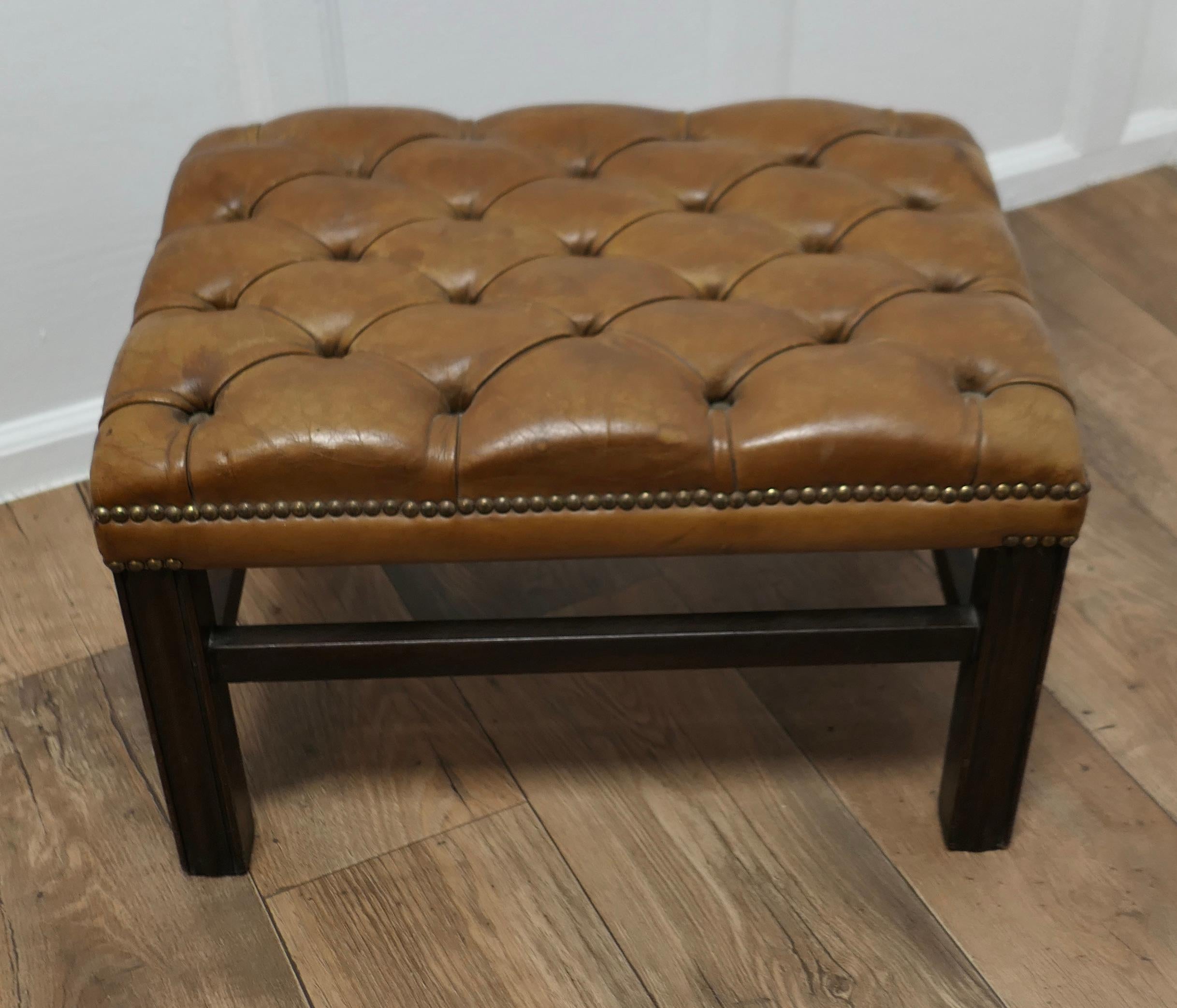 Deeply Buttoned Chesterfield Tan Leather Library Stool 

This is a good Sturdy Library Stool it has sturdy reeded legs with cross stretchers
The stool is upholstered in a Tan Leather this is not new but it is has no tears or holes

This sturdy