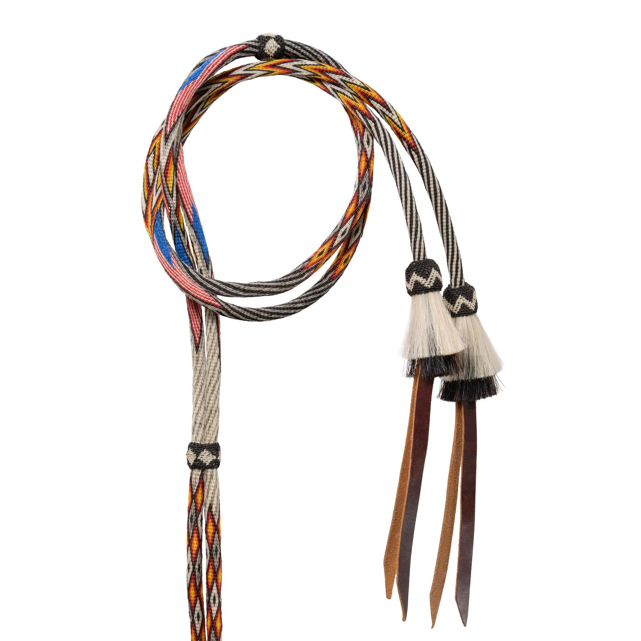 Deer Lodge Prison horsehair bridle in eight colors with American flags, knots, tassels, and glass rosettes within hitch bands with roses on both brow and nose bands. Flat nose, brow and flat cheek bands. On brow band spelled out 