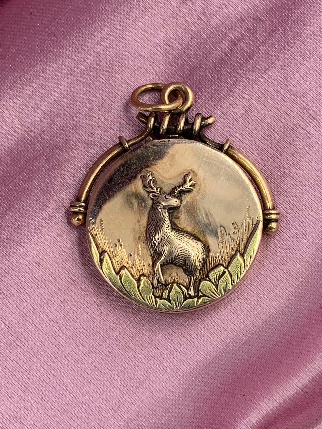 A rare and wonderful antique Belle Epoque, Victorian locket pendant with a beautifully modeled Deer, Stag with handsome antlers standing among grasses and leaves, in 10 Karat Rose Gold.   We love our antique animal jewelry and this one has such