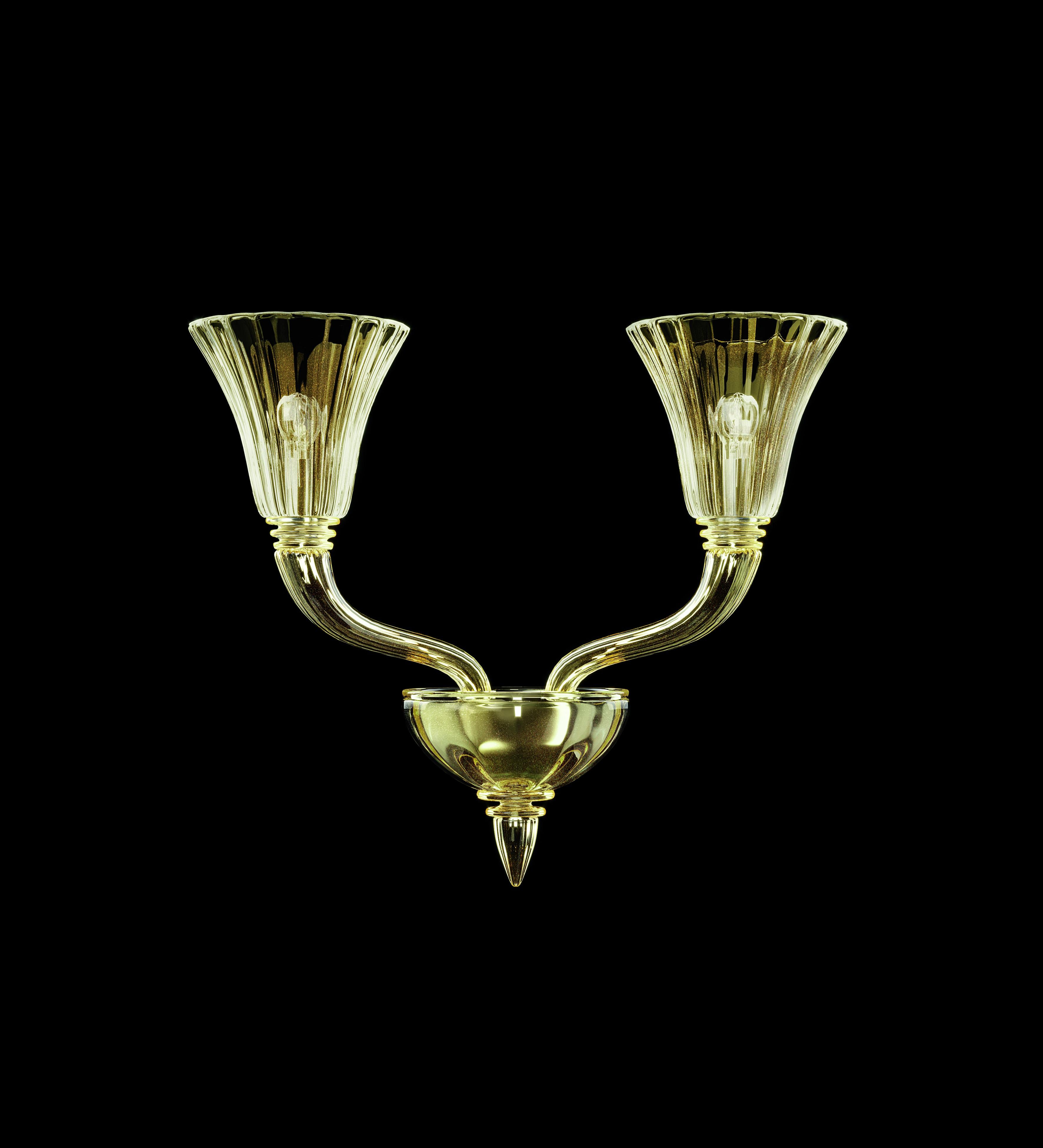 The Degas 5554 wall sconce was originally designed in 2004. Here you are offered the Degas wall sconce in gold blown glass with a galvanized gold finish. This slender chandelier takes its name from one of the most famous impressionists, and has a