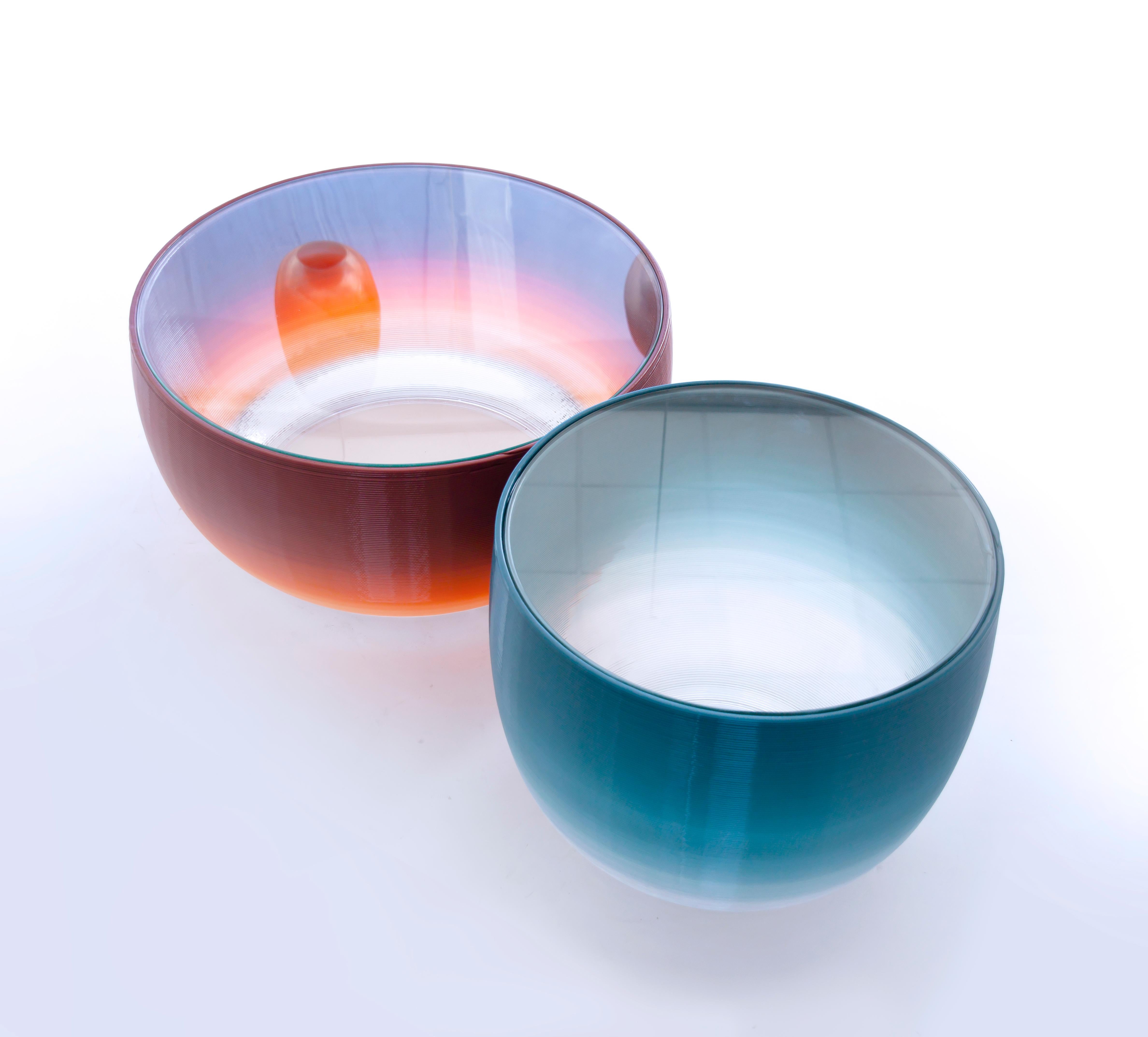 Degradé is a collection of lamps and tables that explores 3D printing technology in order to achieve a unique gradient effect, evoking the color palette that we can find in a clear sunset sky. The pieces are printed in one piece with an industrial