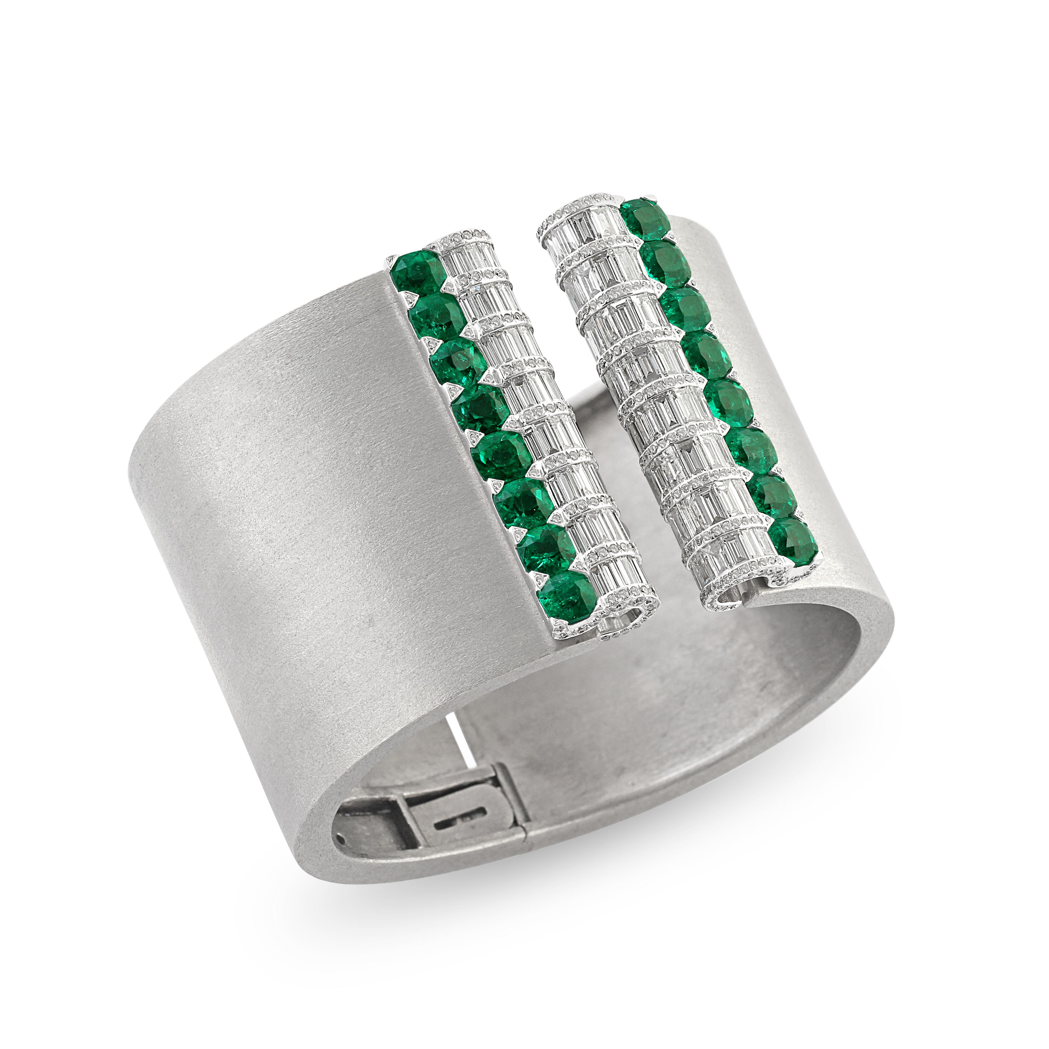 A statement emerald and diamond bangle by DeGrisogono. Crafted from titanium as a thick and chunky cuff the centre is set with detachable emerald and diamond double clips. A rare piece, the detachable clips are an incredible versatile and unique
