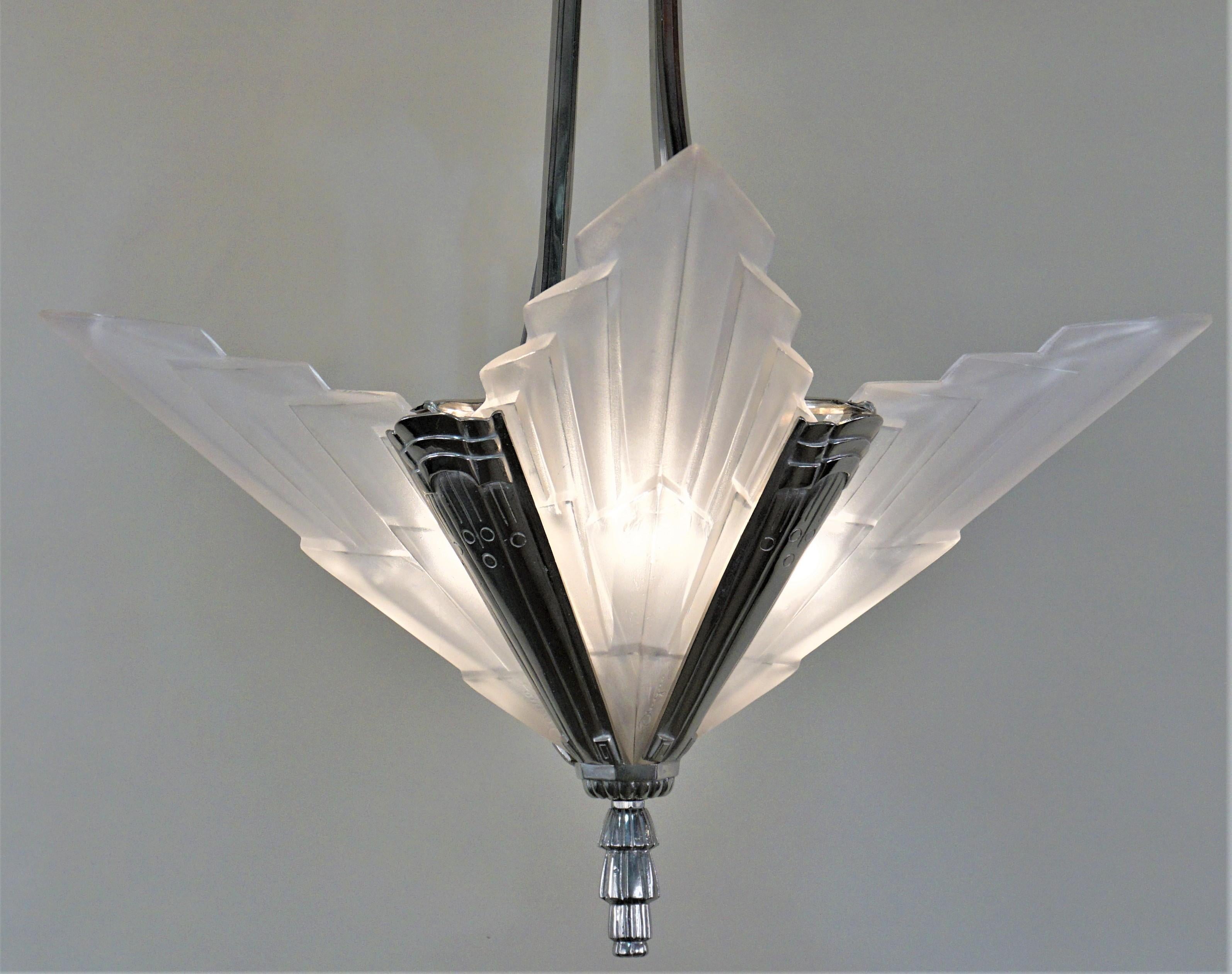 Art Deco chandelier created by David Gueron known as Degue with four clear frost V-shape panels with touch of high light polish with nickel on bronze frame.