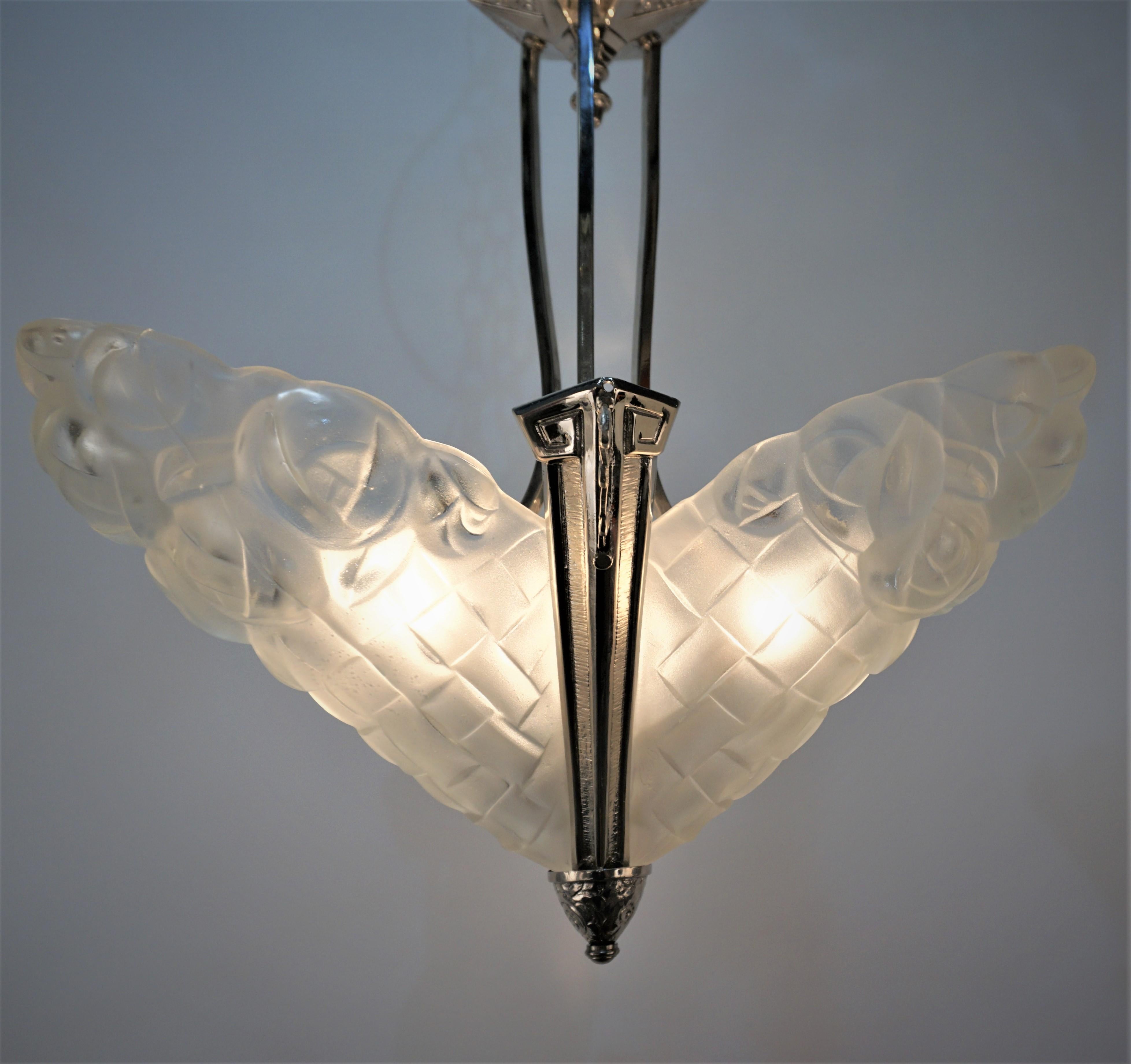 Clear frost glass with elegant nickel on bronze frame c1930's French art deco chandelier by Degue.
Professionally rewired and ready for installation.
Three lights 100 max each.
