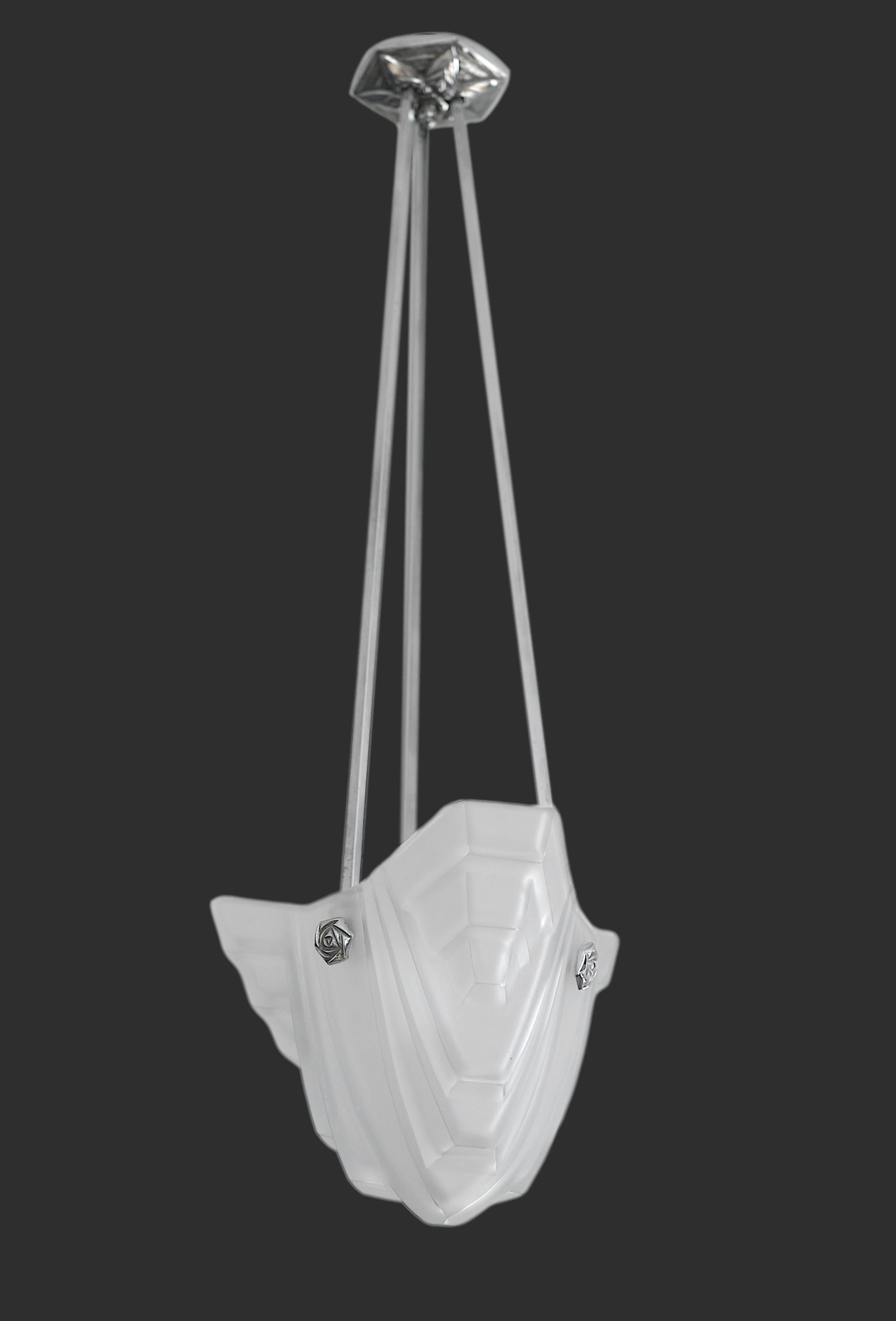 French Art Deco pendant chandelier by DEGUE (Compiegne), France, 1920s. Thick white frosted glass lampshade with an Art Deco stylized pattern. Nickel plated metal frame. Height: 31