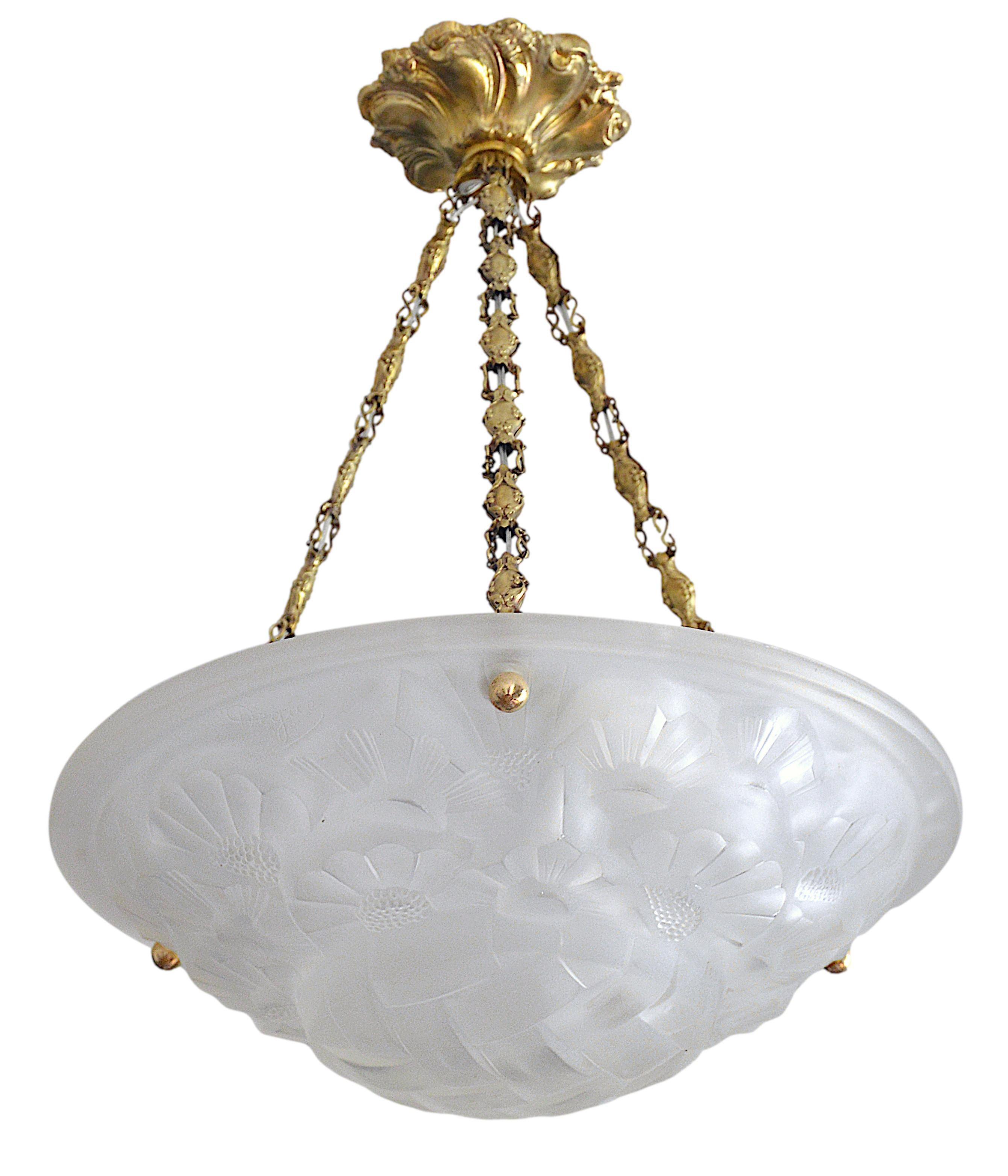 French Art Deco pair of pendants chandeliers by Degue (Compiegne), France, ca. 1930. White frosted glass shade with an Art Deco stylized floral pattern. Stamped brass frame. Height: 17.7