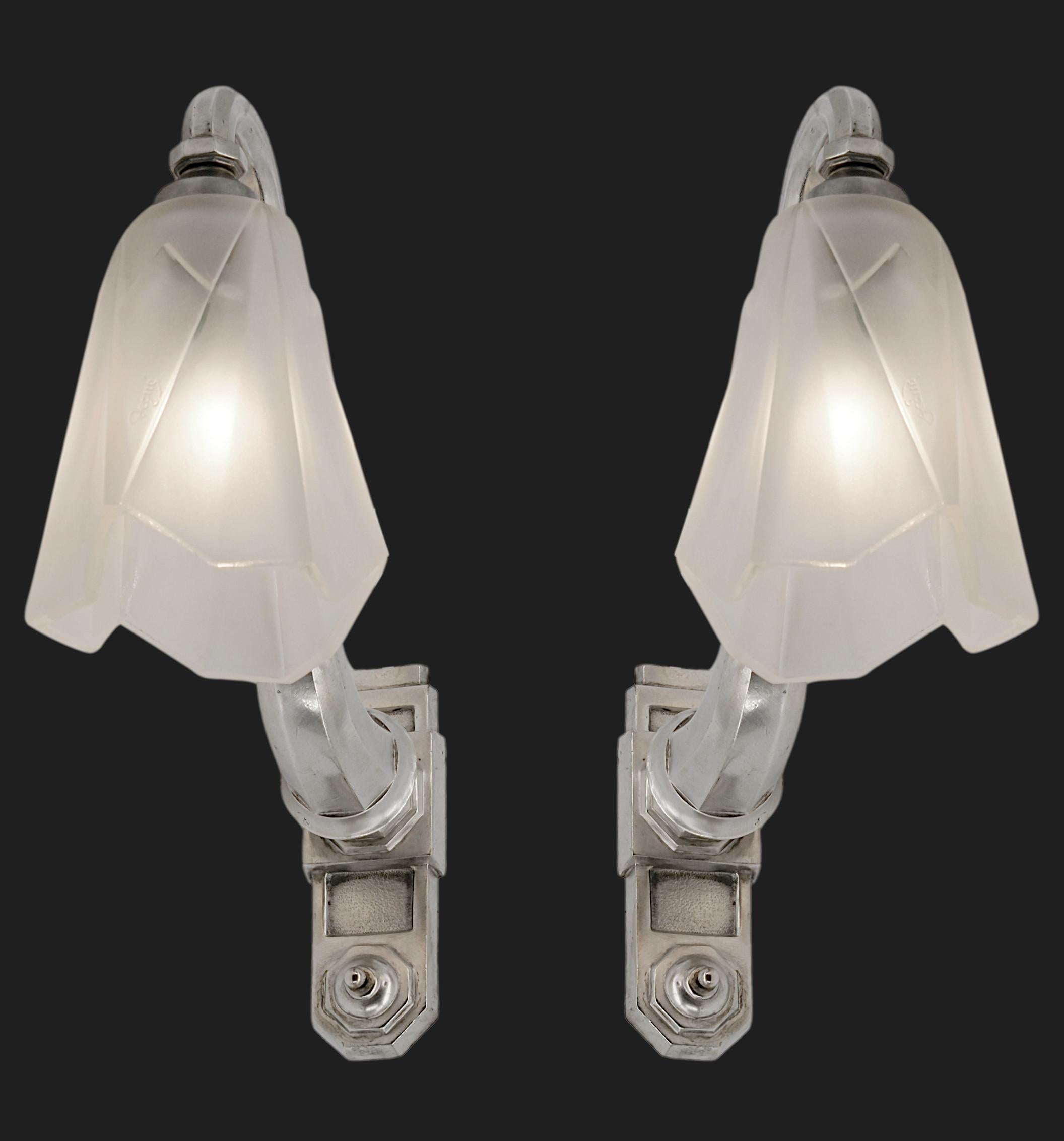 Pair of French Art Deco wall sconces by DEGUE (Compiegne), France, circa 1930. White frosted glass shade hung at their period silver plate solid bronze fixtures. Each - Height: 11.6