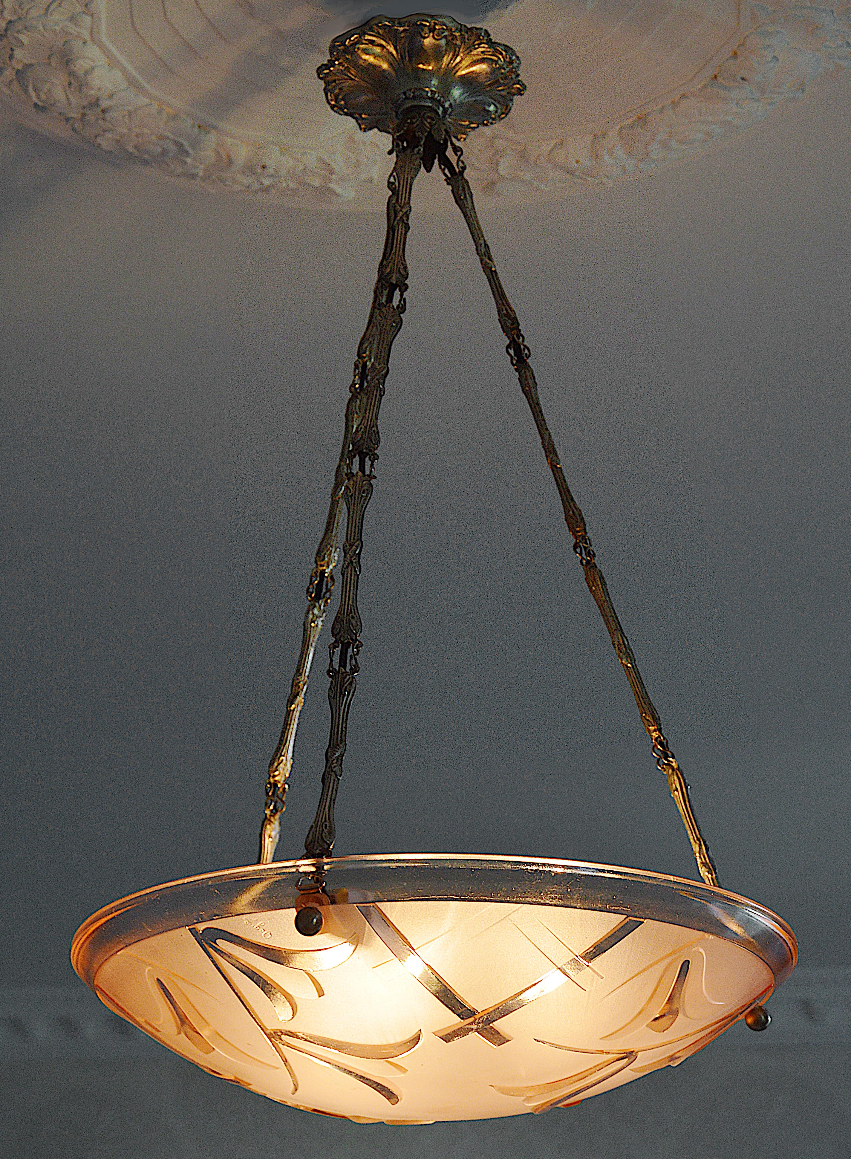 French Art Deco pendant chandelier by Degue (Compiegne), France, late 1920s. Pink frosted glass shads with an Art Deco stylized floral pattern. Stamped brass frame. Height: 24.8