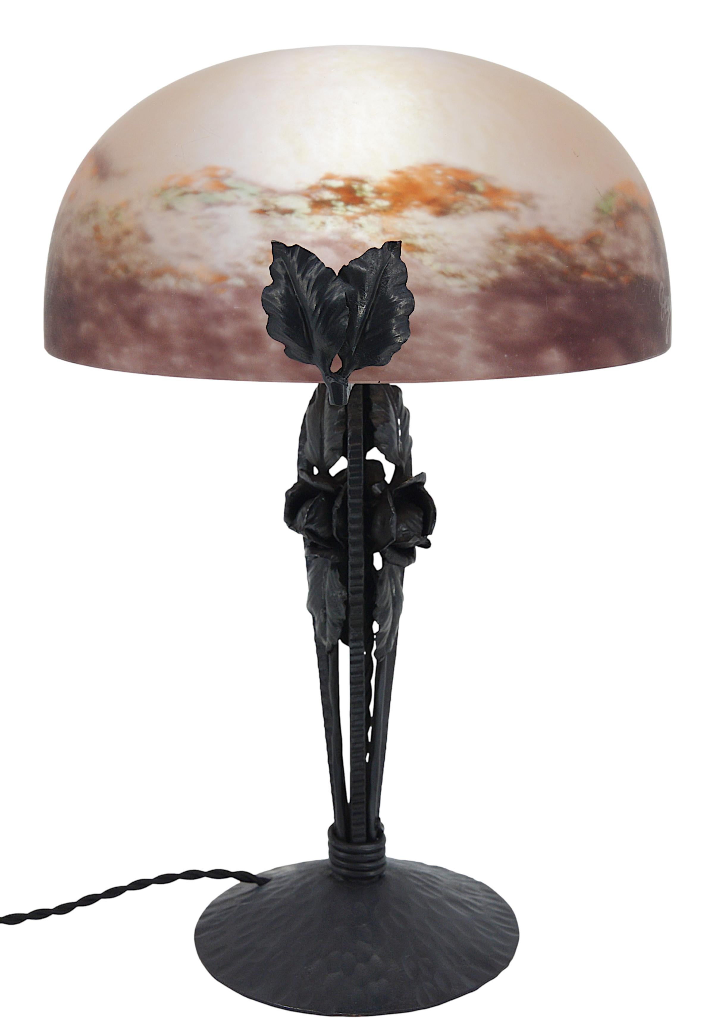 French Art Deco table lamp by DEGUE (Compiegne), France, late 1920s. Mottled glass shade. Colors : purple, orange, green. Wrought-iron base with roses. Height: 14.8