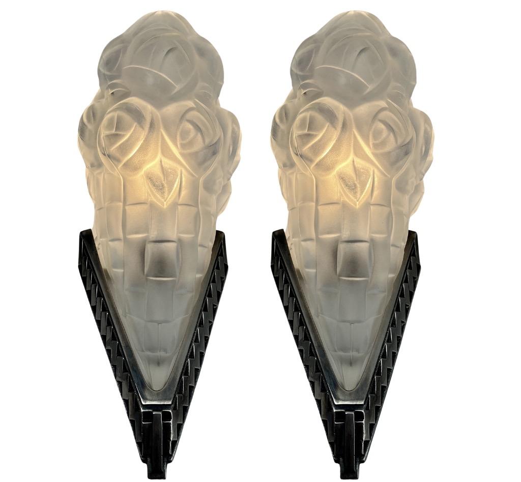 A wonderful Pair French 1930 art deco Sconces lamps made by the Paris based company of Léon Hugue, A nickel plated solid brass or bronze base holds a signed dome shaped shade by Degué. Done in clear frosted moulded-pressed glass.
Léon Hugue was a
