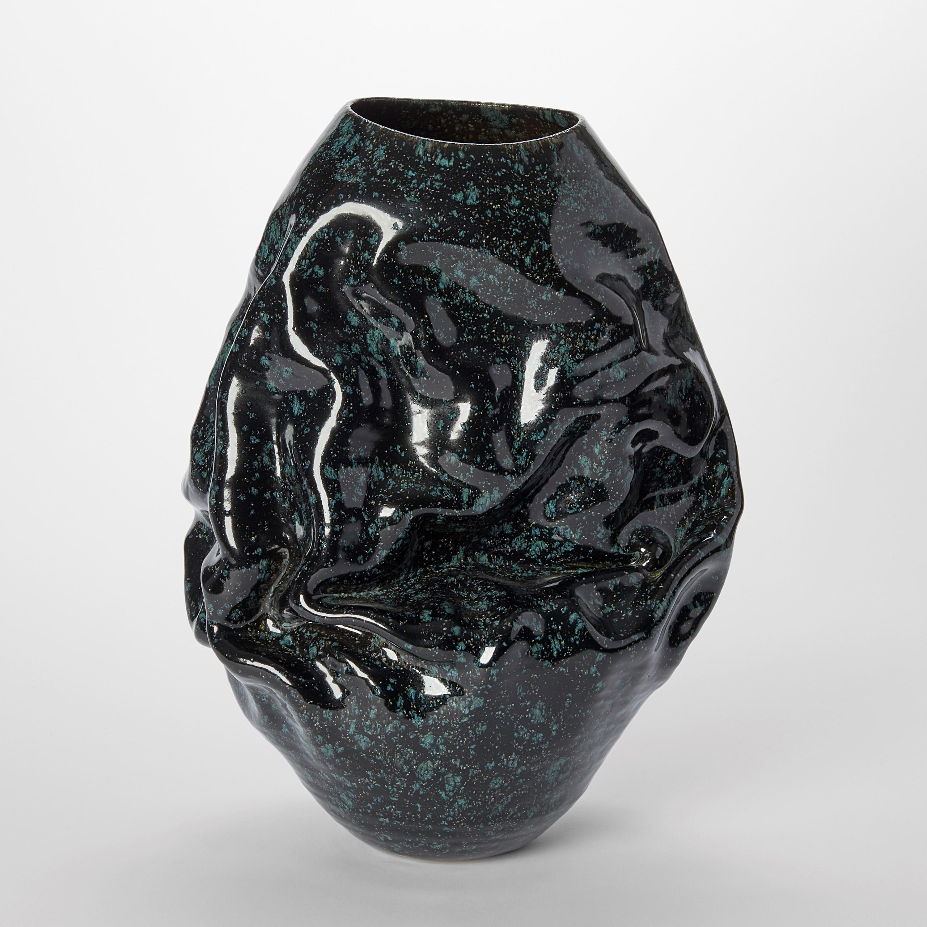 ‘Dehydrated Form with Cosmic Black Glaze No 115’ is a unique sculptural vessel by the British artist, Nicholas Arroyave-Portela.

Nicholas Arroyave-Portela’s professional ceramic practise began in 1994. After 20 years based in London, he moved and