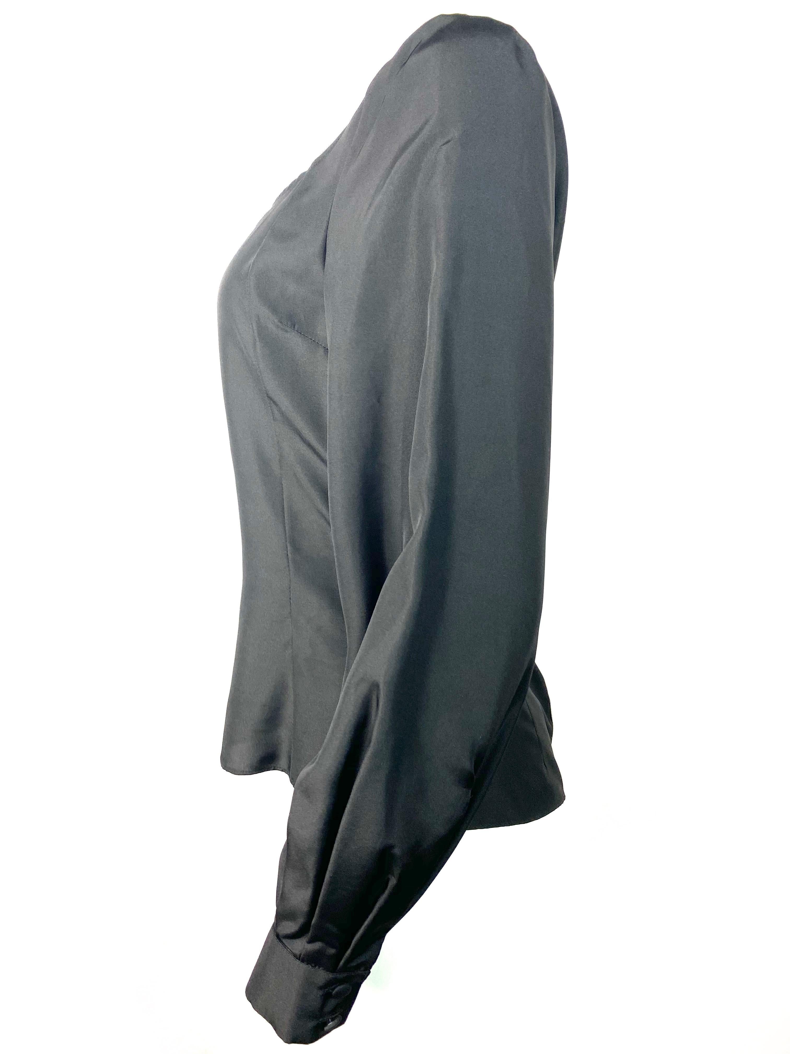 Product details:

Featuring, black, silk, silver tone rear zip closure set in metallic silver fabric, two buttons closure on the bottom of each sleeve.