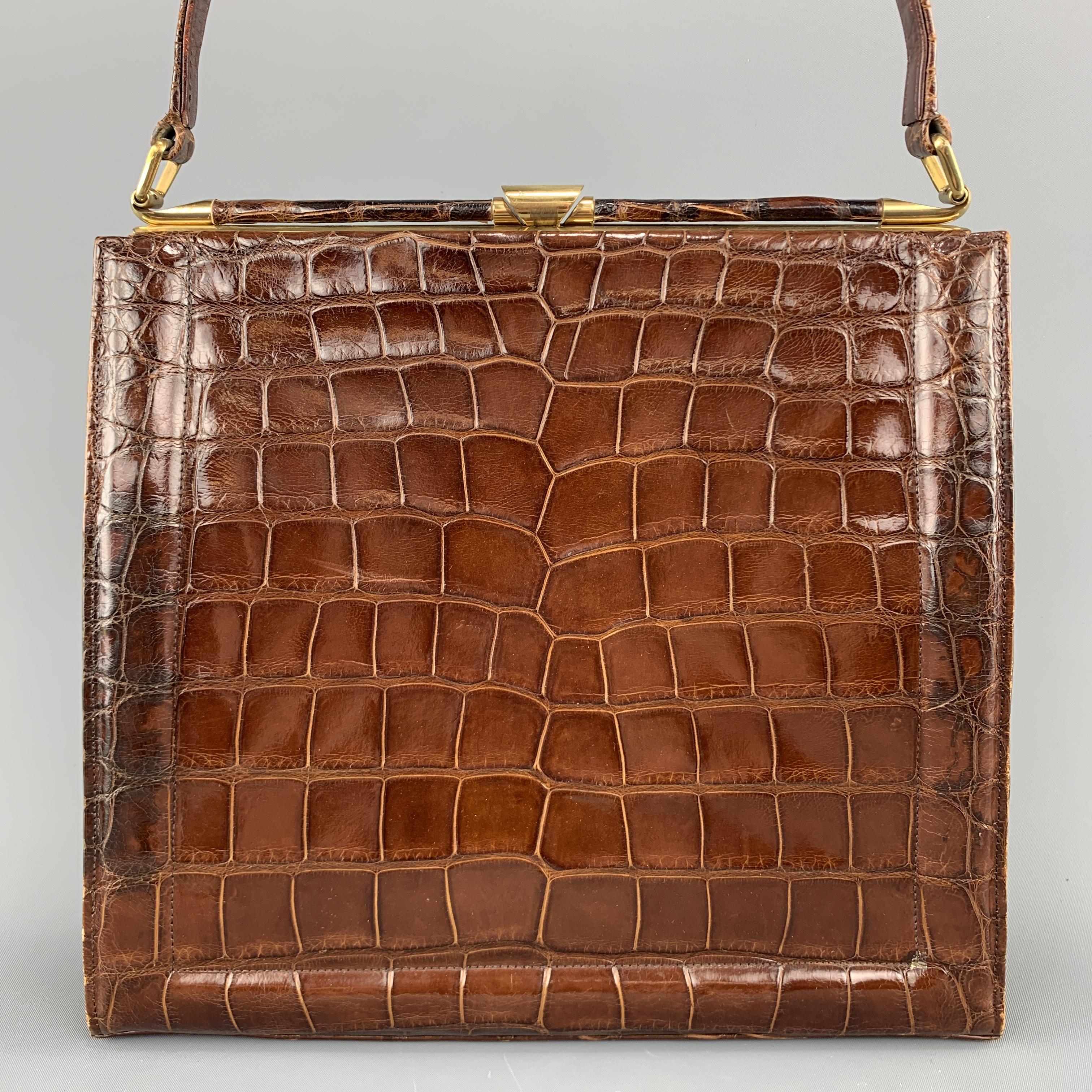 Vintage 50's-60's DEITSCH handbag comes in brown alligator skin leather with a single strap and gold tone brass closure.
 
Very Good Pre-Owned Condition.
 
Measurements:
 
Length: 11 in.
Width: 2.5 in.
Height: 10 in.
Drop: 6.5 in.