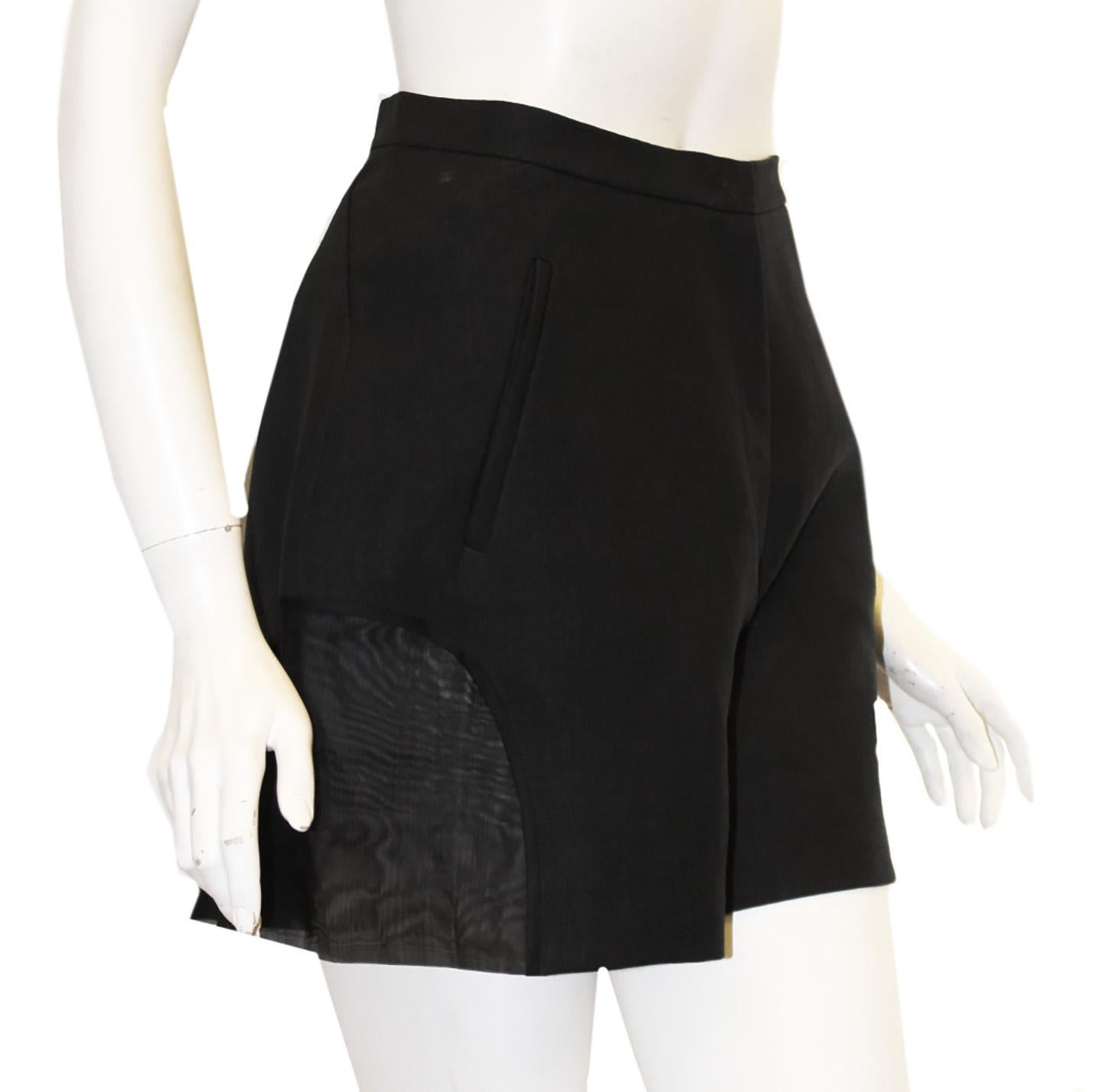 Del Pozo black paper and cotton blend shorts harmonizes novel materials with modern construction in these high waisted shorts.  are detailed with sheer half-moon inserts at the hem.  For closure, front zipper and hook and eye.  These shorts are not