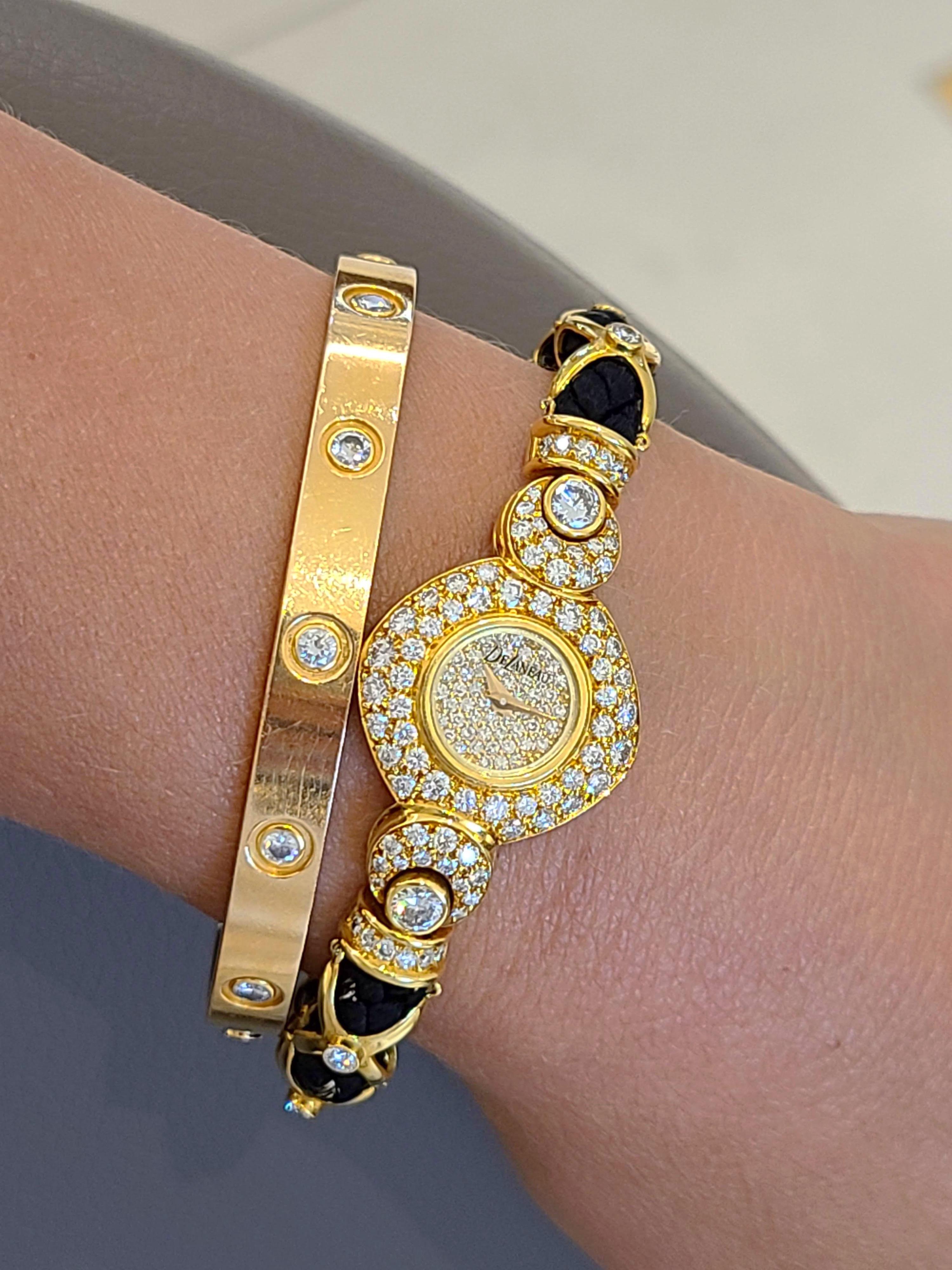 DeLaneau was founded by a woman in 1949 in Switzerland. They are one of the first watch companies to devote their entire collection to ladies timepieces.
The face of this 18 karat yellow gold cushion shaped watch is set with pave diamonds. The bezel