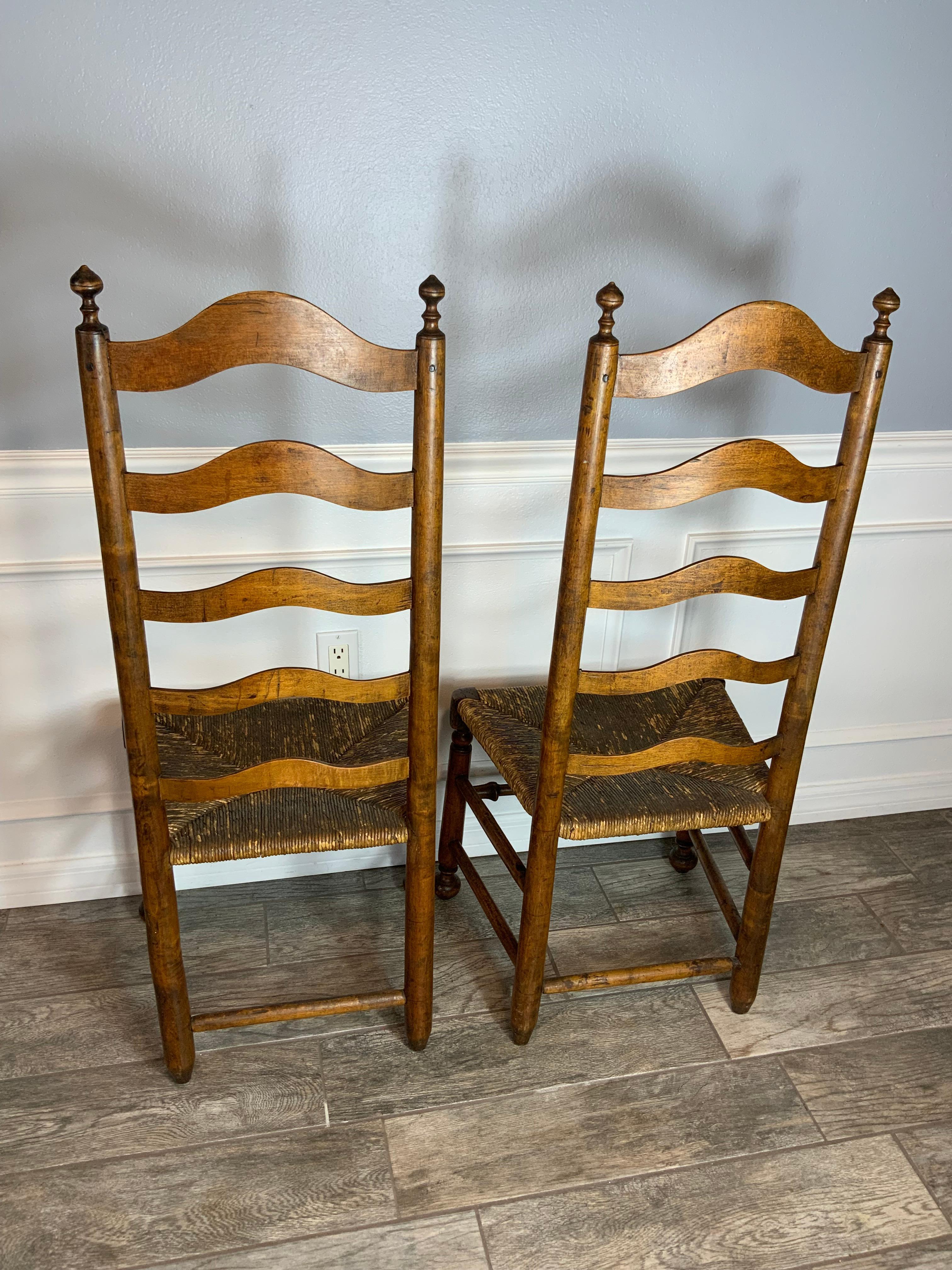 Very nice clean matching pair of Maple Delaware River Valley arched five slat Ladder Back side chairs.  Straight rounded stiles topped with inverted turnip shaped finials.  Five graduated arched shaped slats with the top slat tenon pegged.  Turned