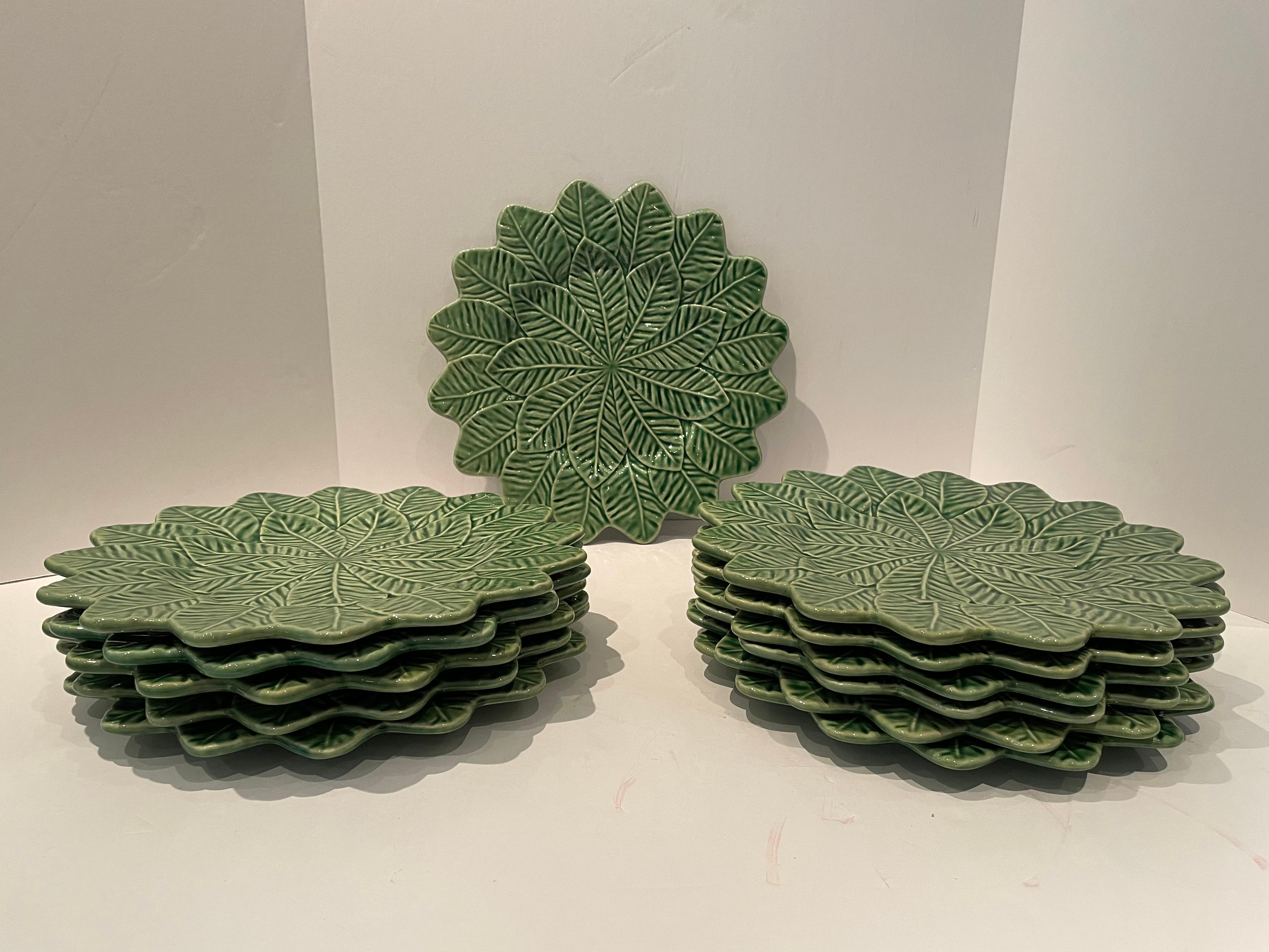 A beautiful set of 12 vintage majolica charger plates from Portugal having an incised double leaf design and leaf shaped edge. This pattern is no longer made. Never used and has original boxes.