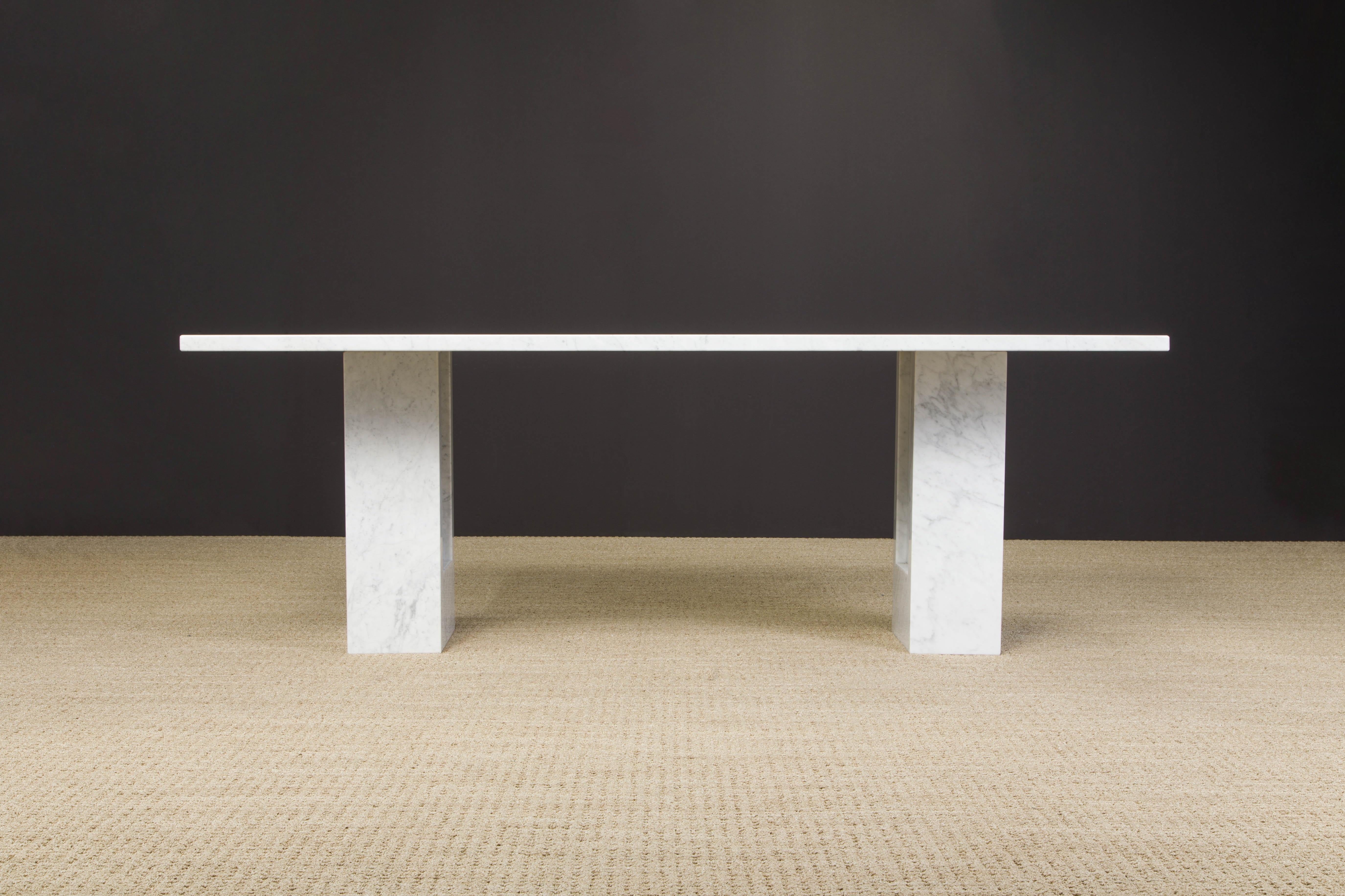 This incredible 'Delfi' dining table designed by Carlo Scarpa and Marcel Breuer is composed of two sculptural Carrara marble bases and a matching thick rectangular marble top which has inset pins that fit into the bases to increase the stability and