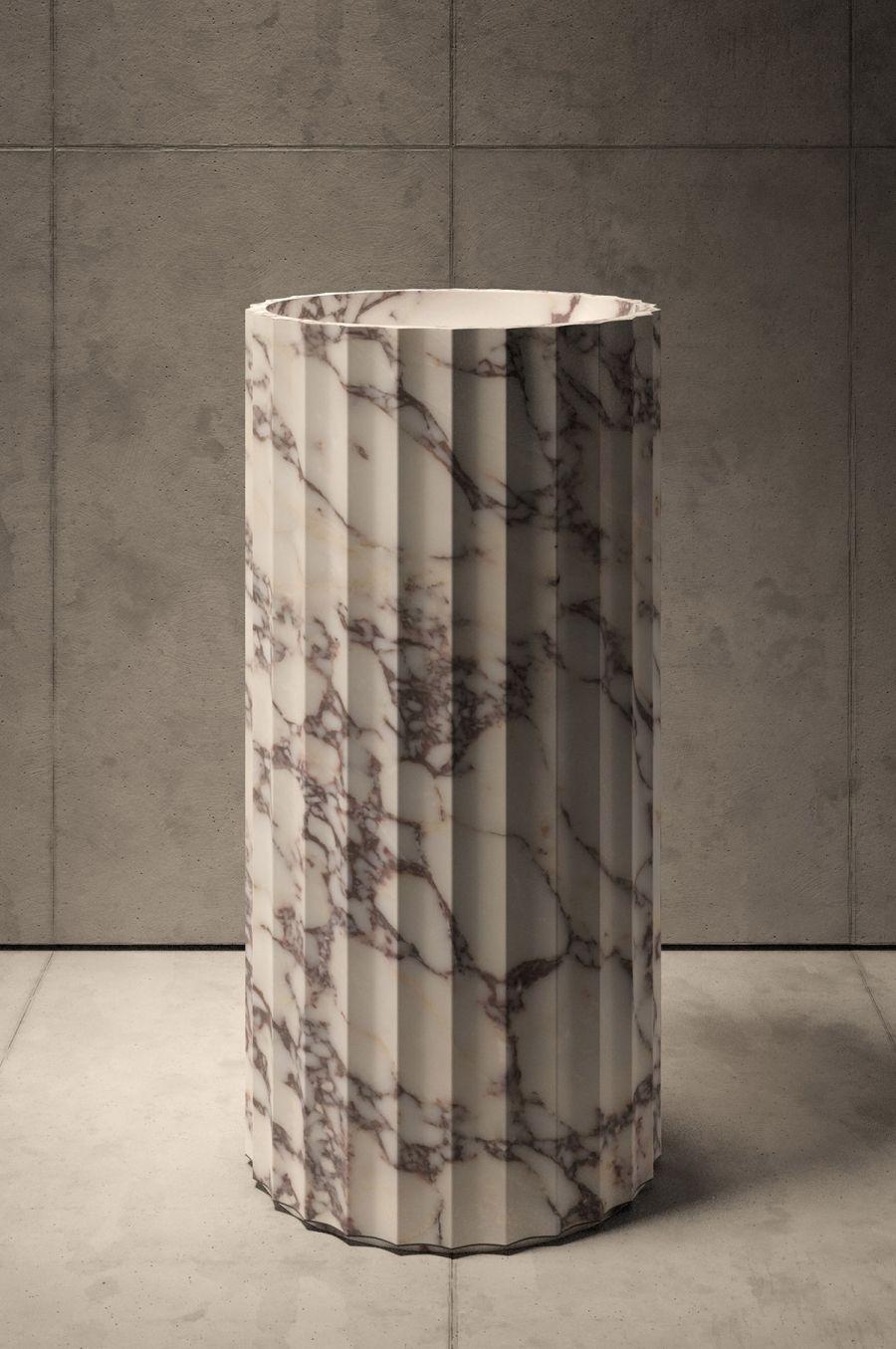 Crafted in exquisite Calacatta Viola marble, this Piba Marmi pedestal is a unique expression of nature's beauty and versatility. The intricate detailing of the fluted surface showcases the artisan's skill and attention to detail. The one-of-a-kind