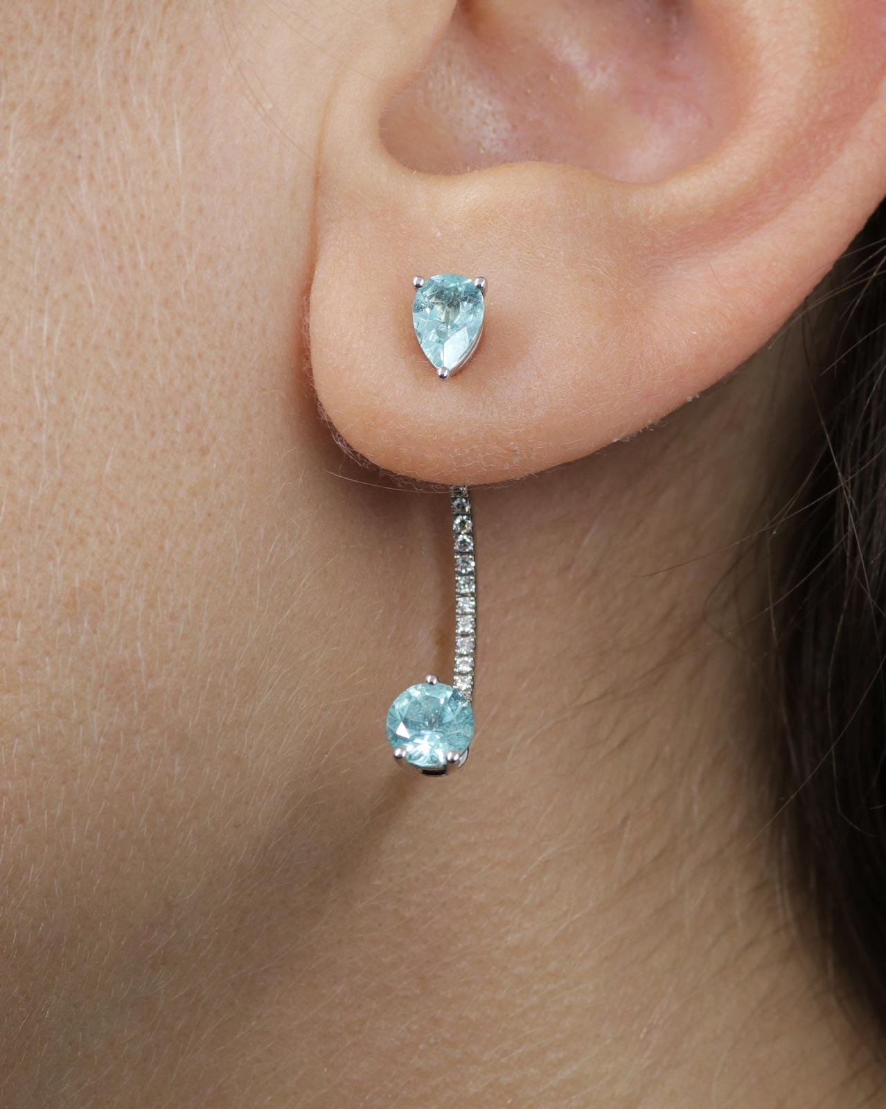 These one of a kind Paraiba drop earrings designed by Italian jeweller Delfina Delettrez are handcrafted in her roman atelier from 18 karat white gold 4,83 gr and feature a curved band embellished with channel set of white diamonds 0.20 ct and