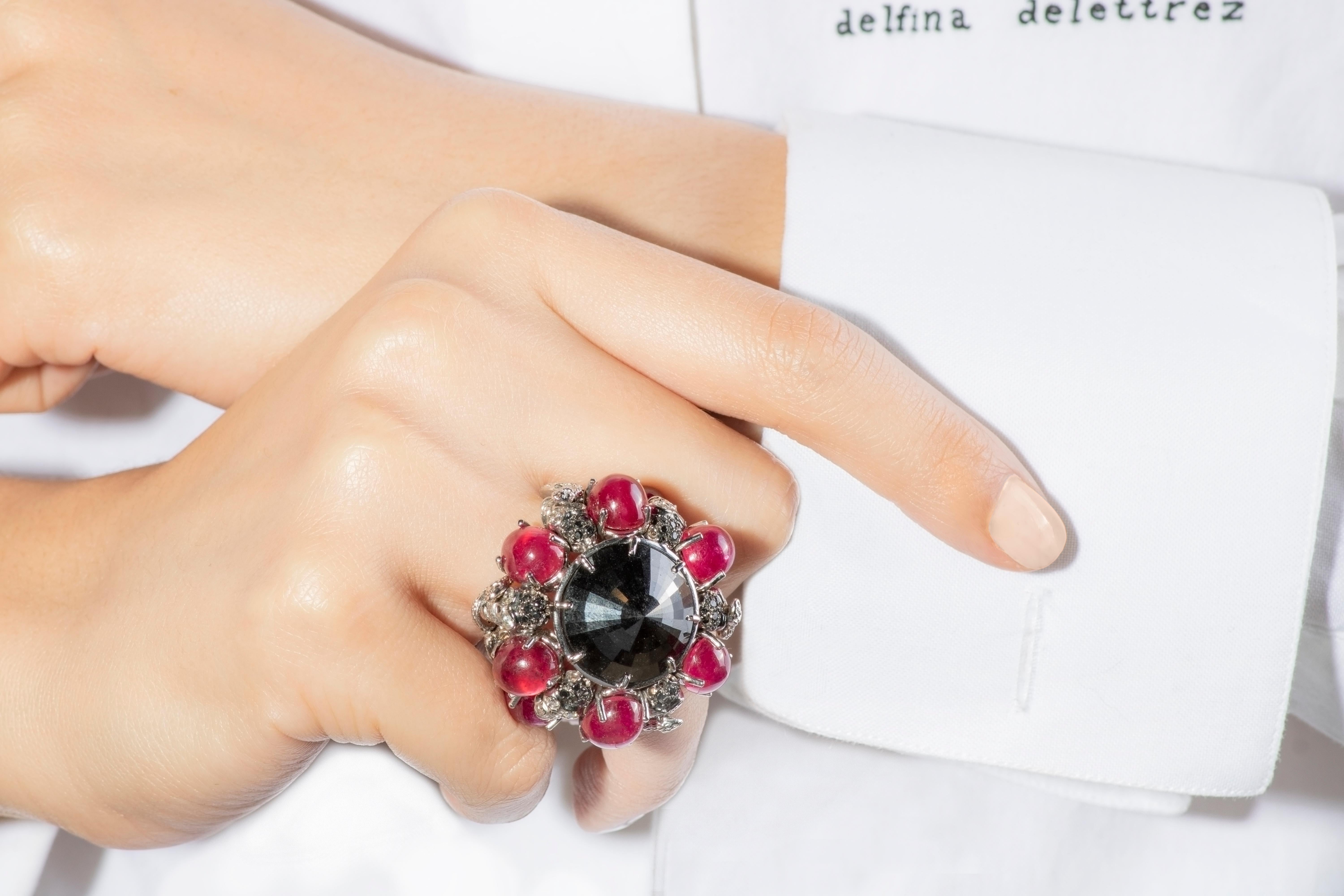 This unique ring by italian jeweller Delfina Delettrez stands out for its large black diamond 23,00 ct and its design ispired by victorian era. It is handcrafted from 30 gr gold and embellished with 8 rubies cabochon 35,87 ct placed around the