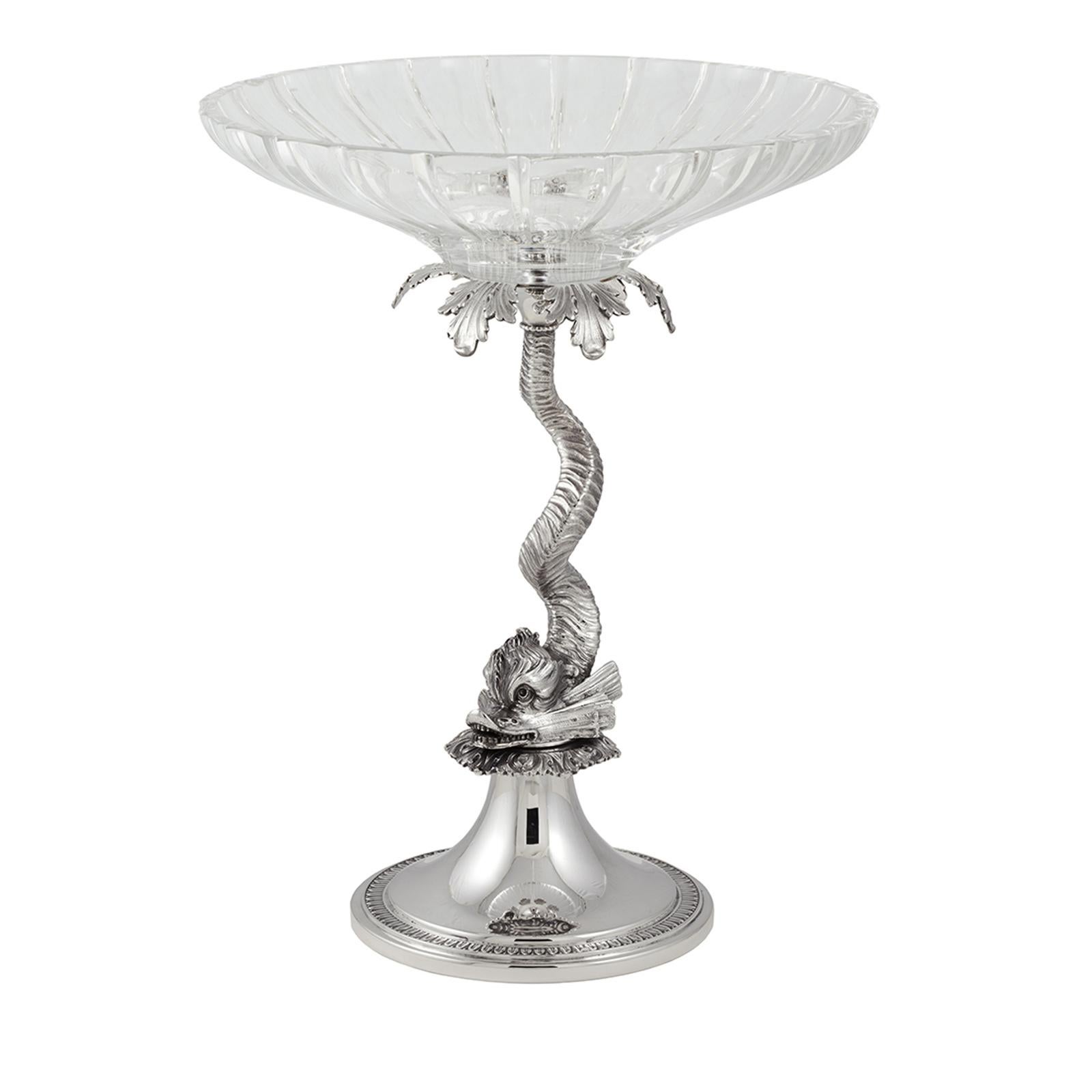 This magnificent stand can be displayed alone as centrepiece or it can support a dessert, or be paired with the Delfini caviar bowl to continue the neoclassical decorative theme of the dolphin that here appears in one single animal supporting the